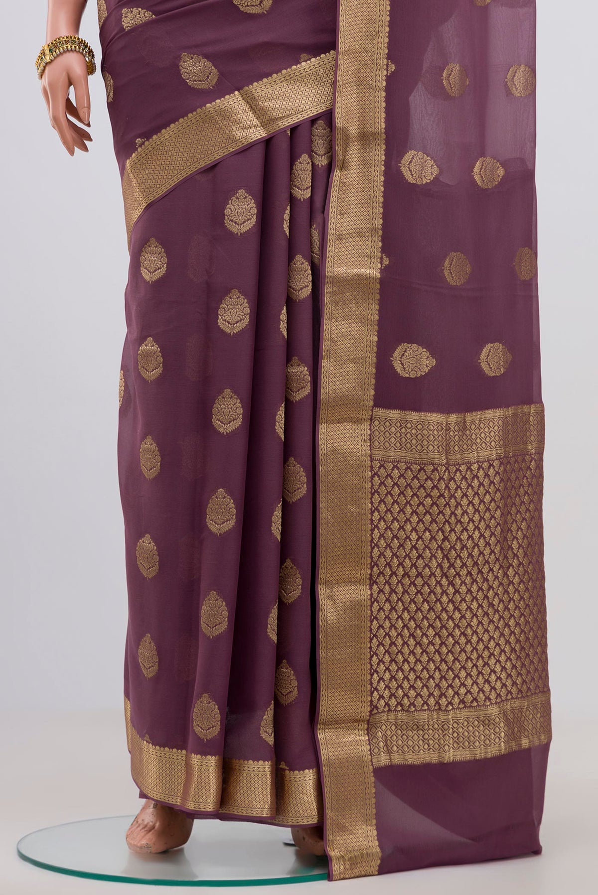 Pleats and pallu of Lavender Georgette Saree with Fancy on the body and Zari Border. 