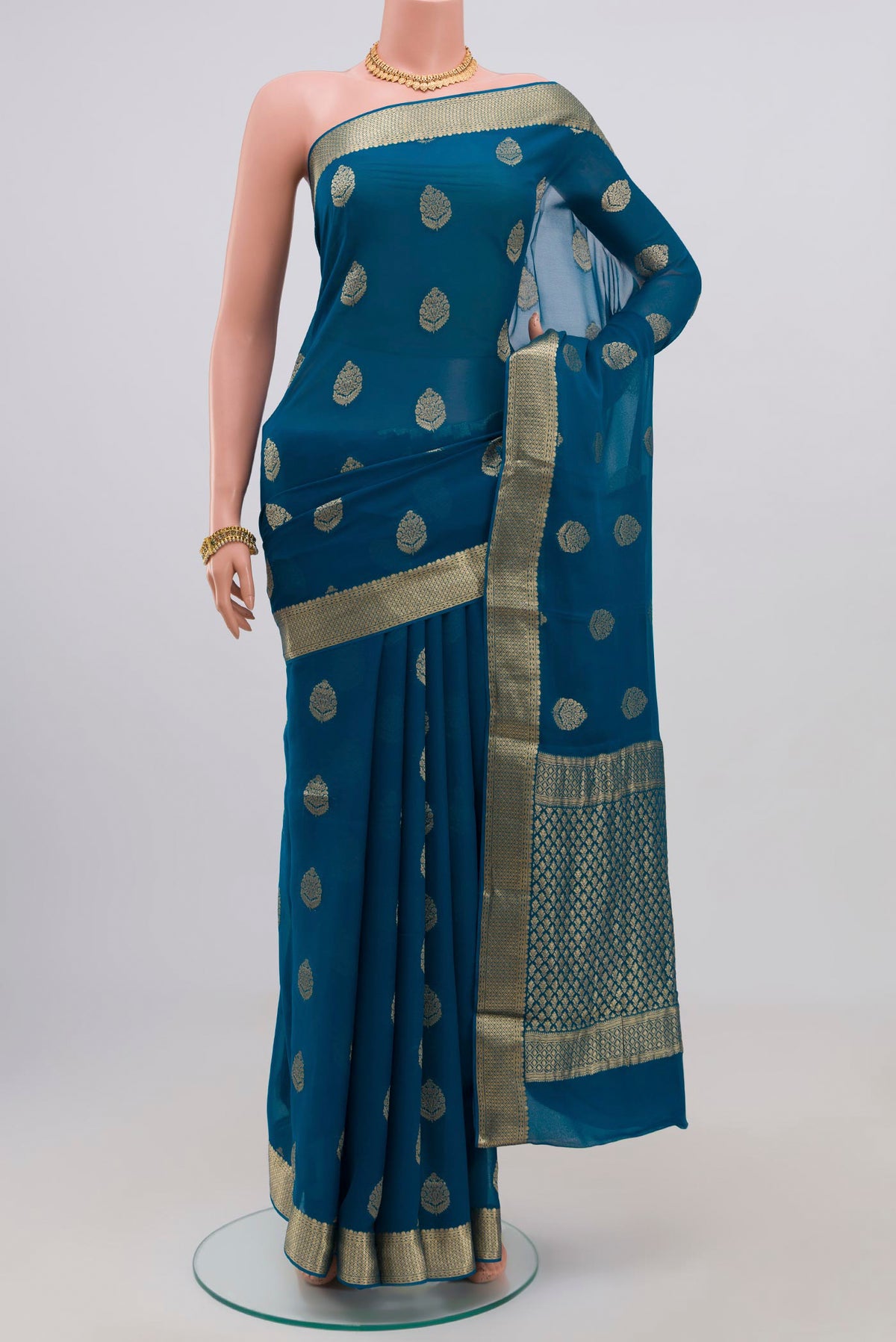 Blue Georgette Saree with Fancy on the body and Zari Border.  displayed on a mannequin