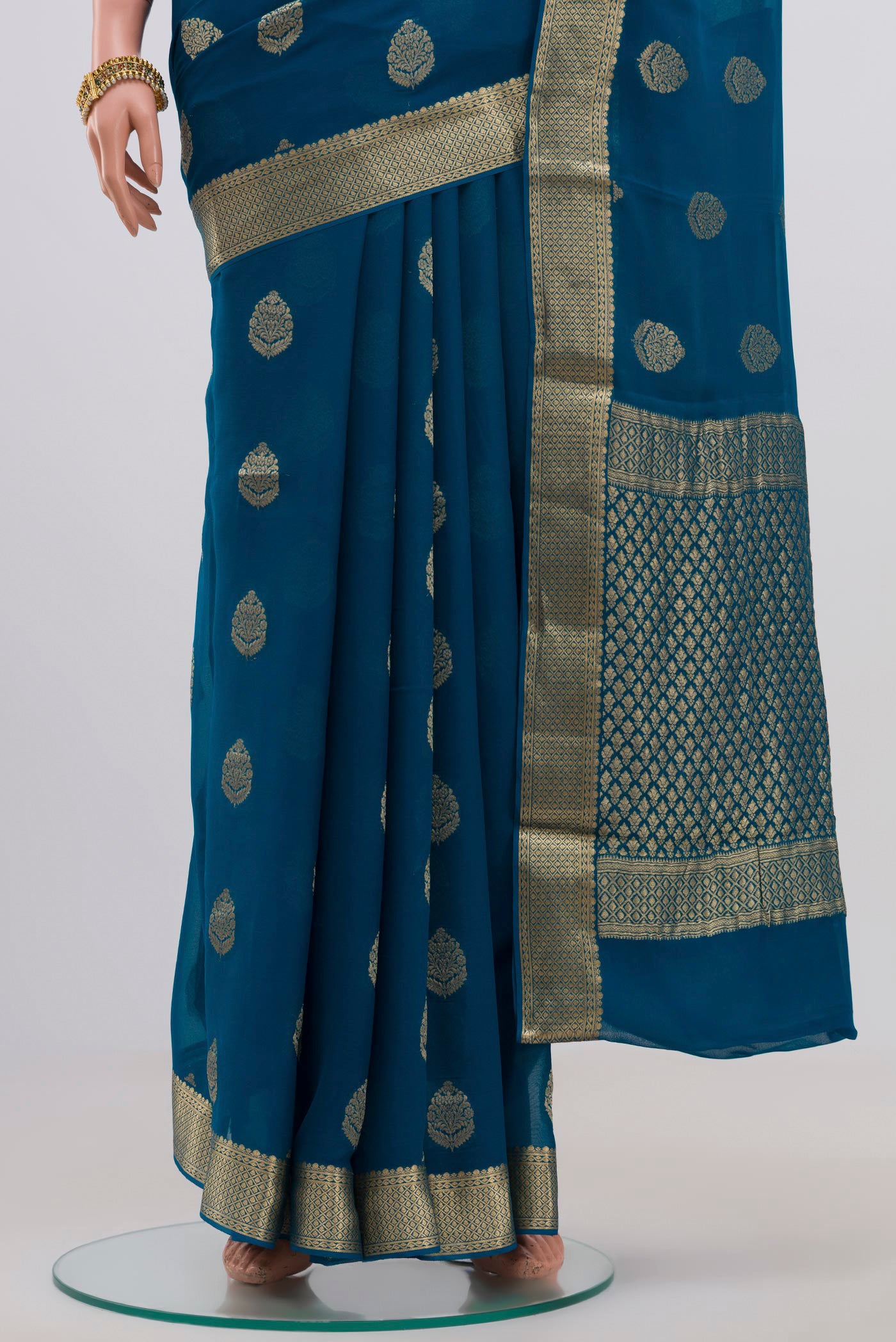 Pleats and pallu of Blue Georgette Saree with Fancy on the body and Zari Border. 