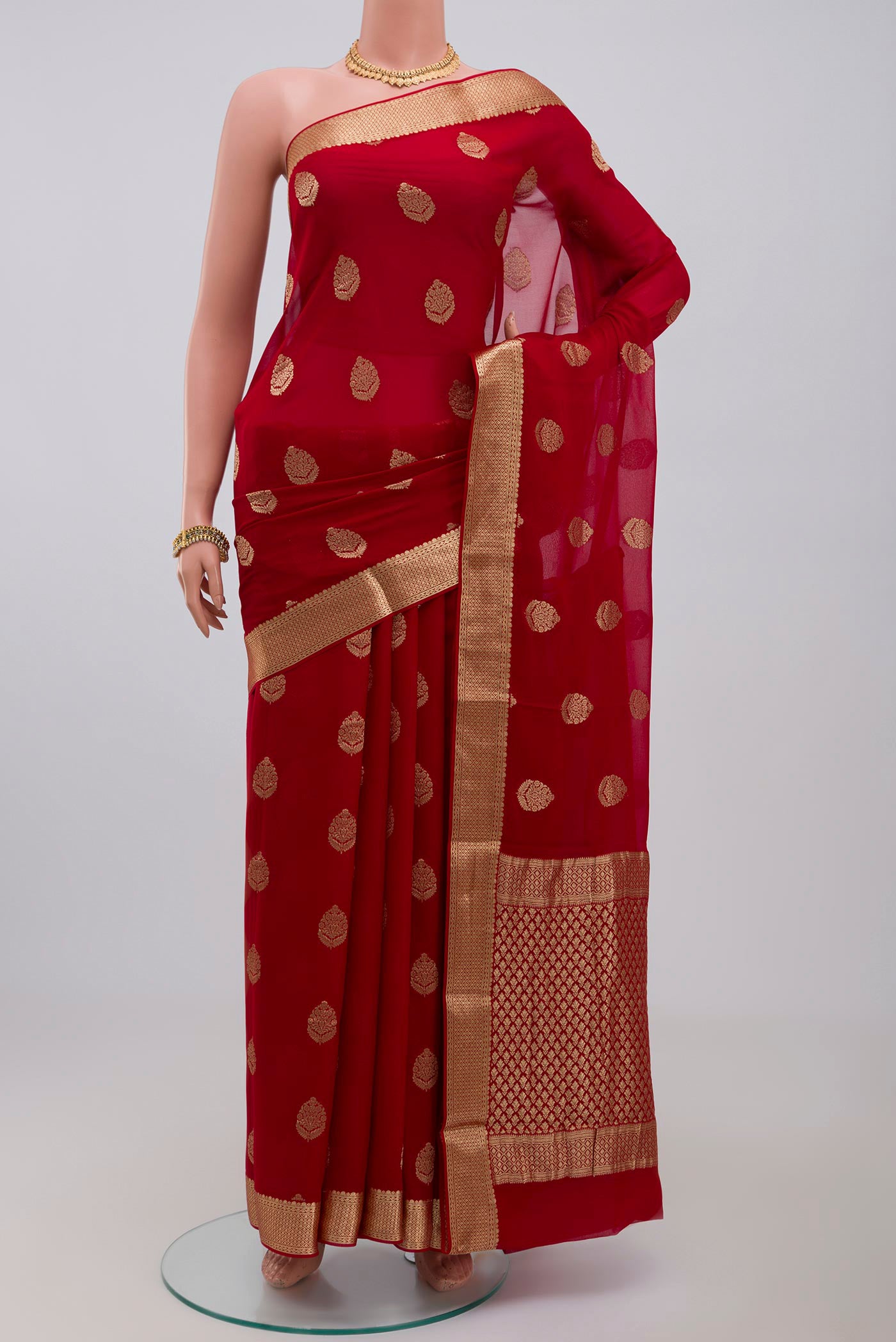 Red Georgette Saree with Fancy on the body and Zari Border.  displayed on a mannequin