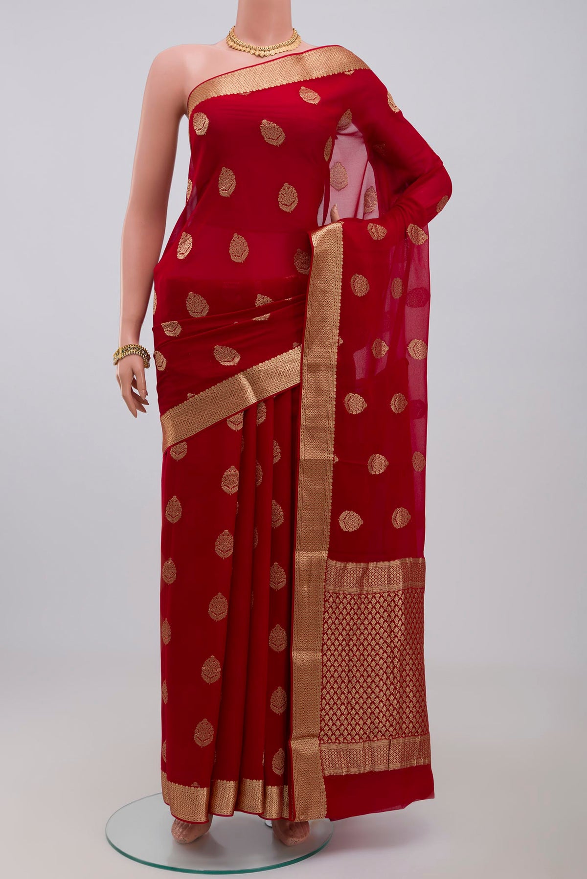 Red Georgette Saree with Fancy on the body and Zari Border.  displayed on a mannequin