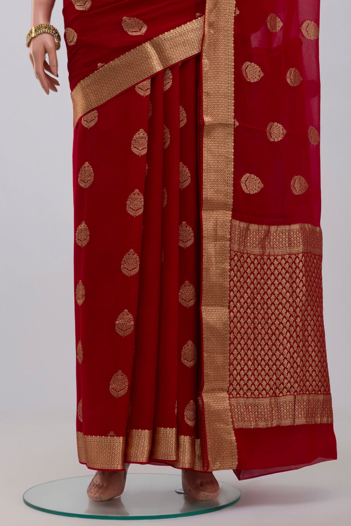 Pleats and pallu of Red Georgette Saree with Fancy on the body and Zari Border. 