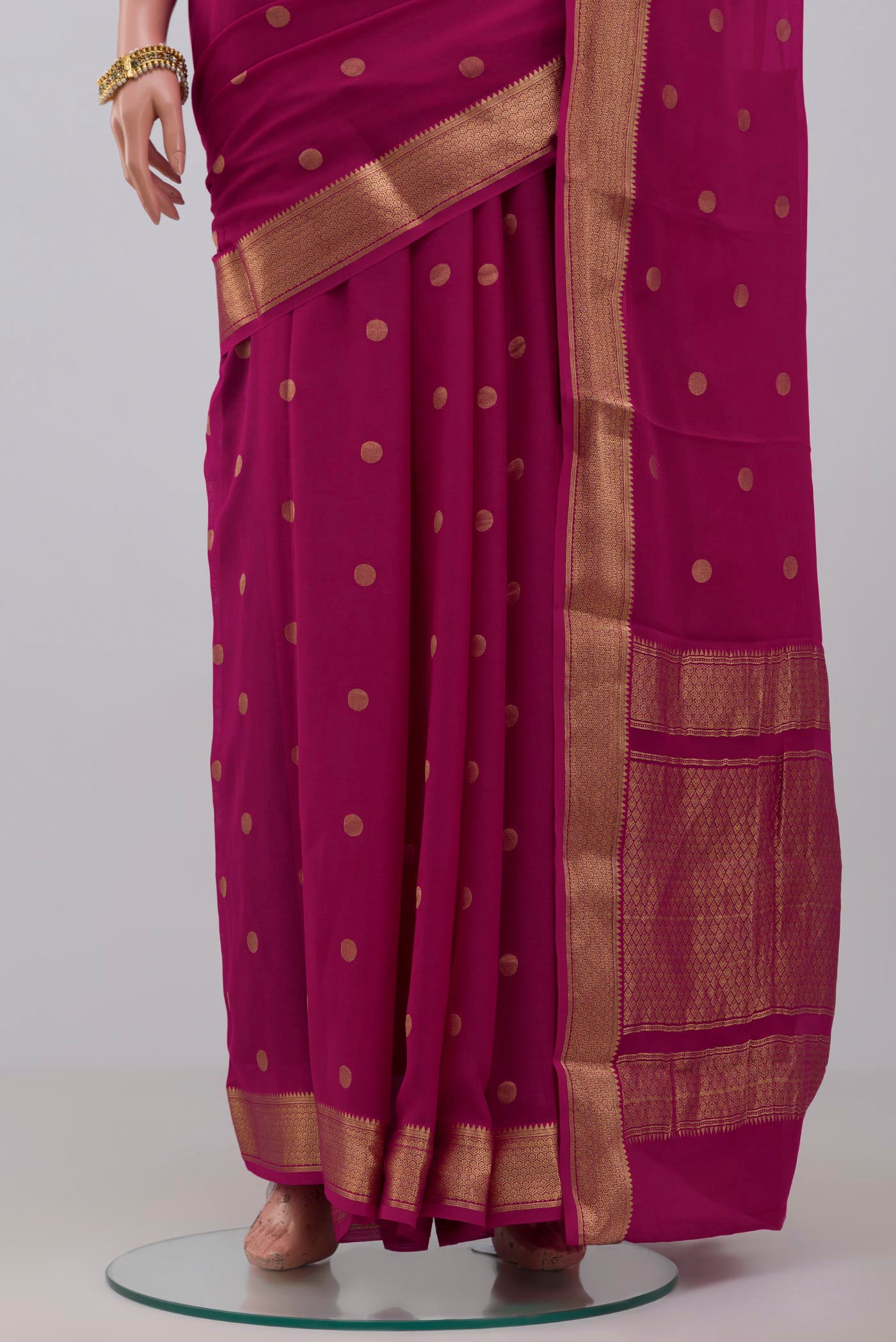 Pleats and pallu of Pink Georgette Saree with Zari Butta on the body and Zari Border. 