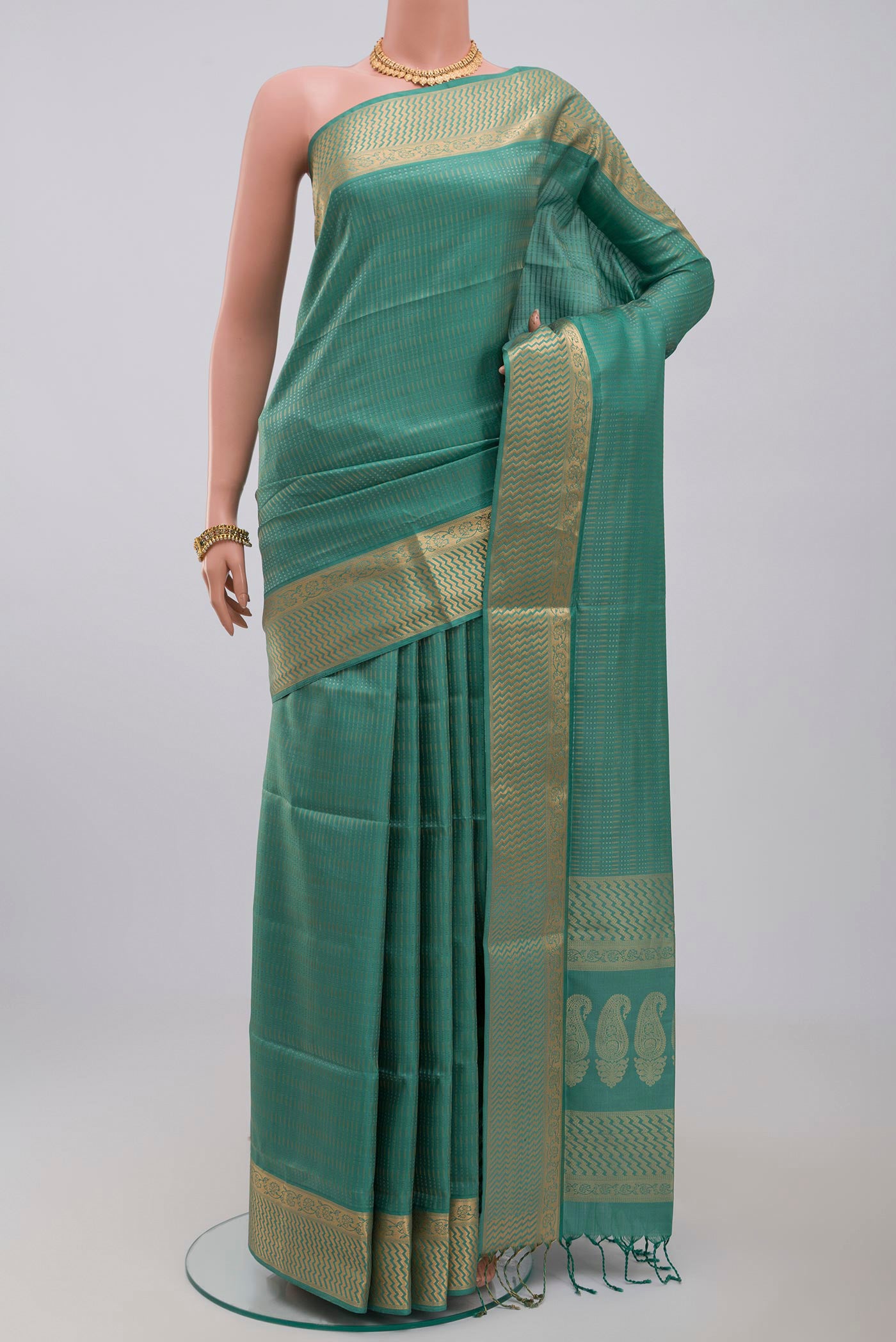 Green Soft Silk Saree with Jacquard design on the body and Zari Border.  displayed on a mannequin