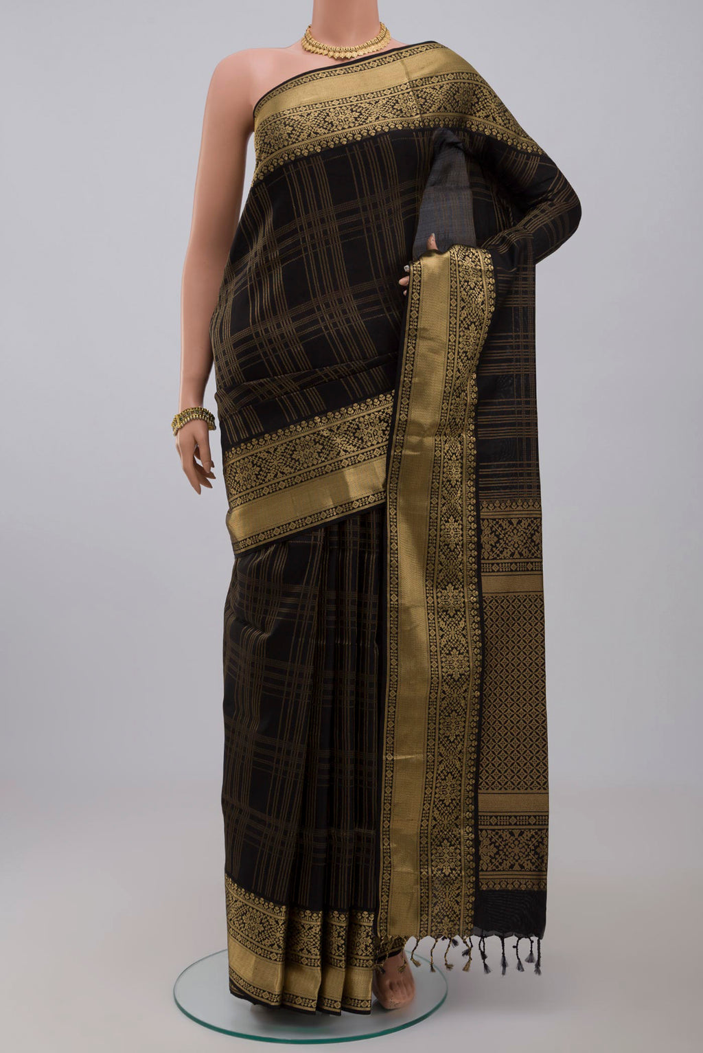 Black Soft Silk Saree with Checked design on the body and Zari Border.  displayed on a mannequin