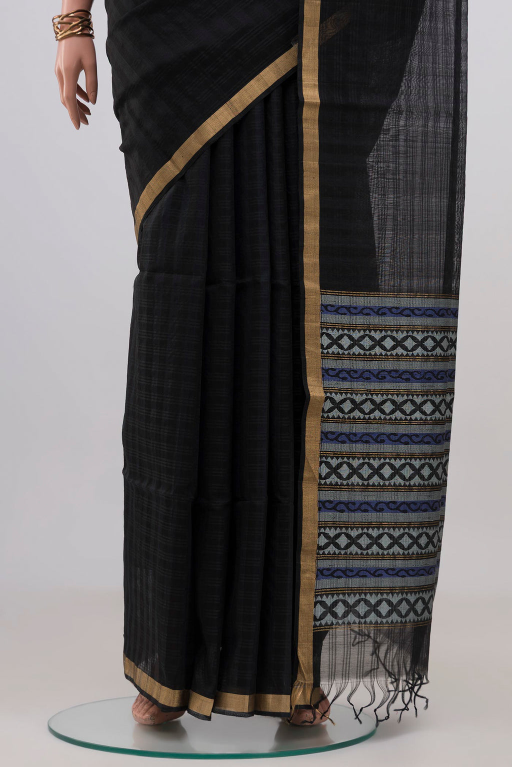 Pleats and pallu of Black Silk Cotton Saree with Plain Body and Thin Zari Line. 