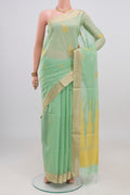 Pista Green Silk Cotton Saree with Zari And Thread Butta on the body and Zari Border.  displayed on a mannequin