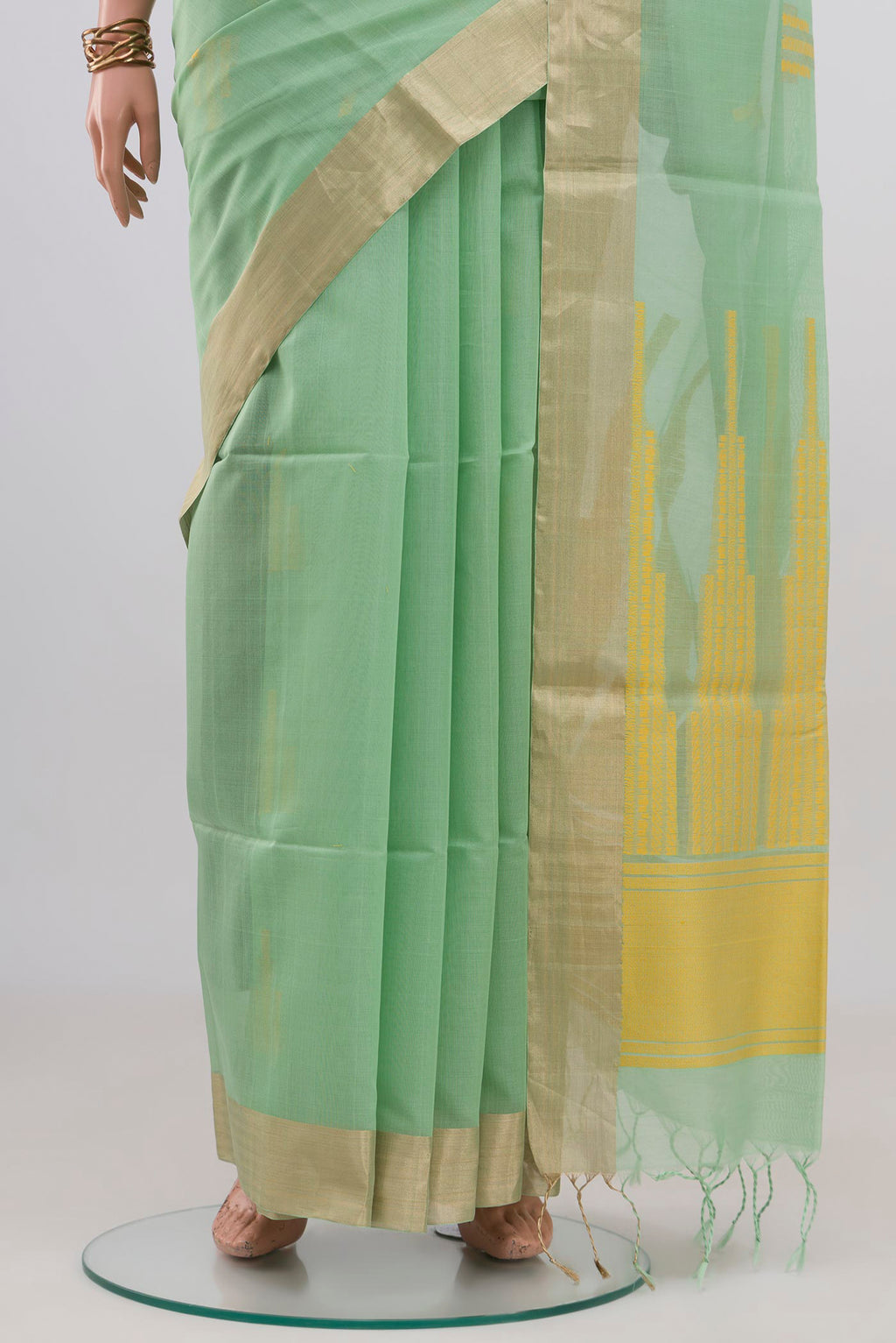 Pleats and pallu of Pista Green Silk Cotton Saree with Zari And Thread Butta on the body and Zari Border. 
