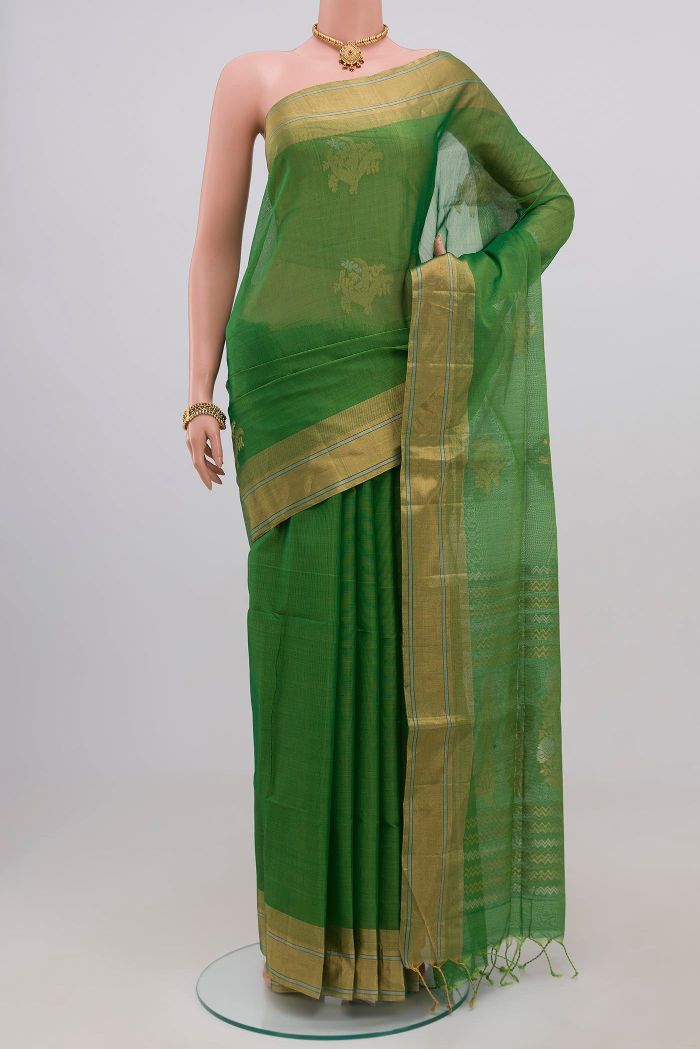 Green Silk Cotton Saree with Zari Butta on the body and Thin Zari Line.  displayed on a mannequin