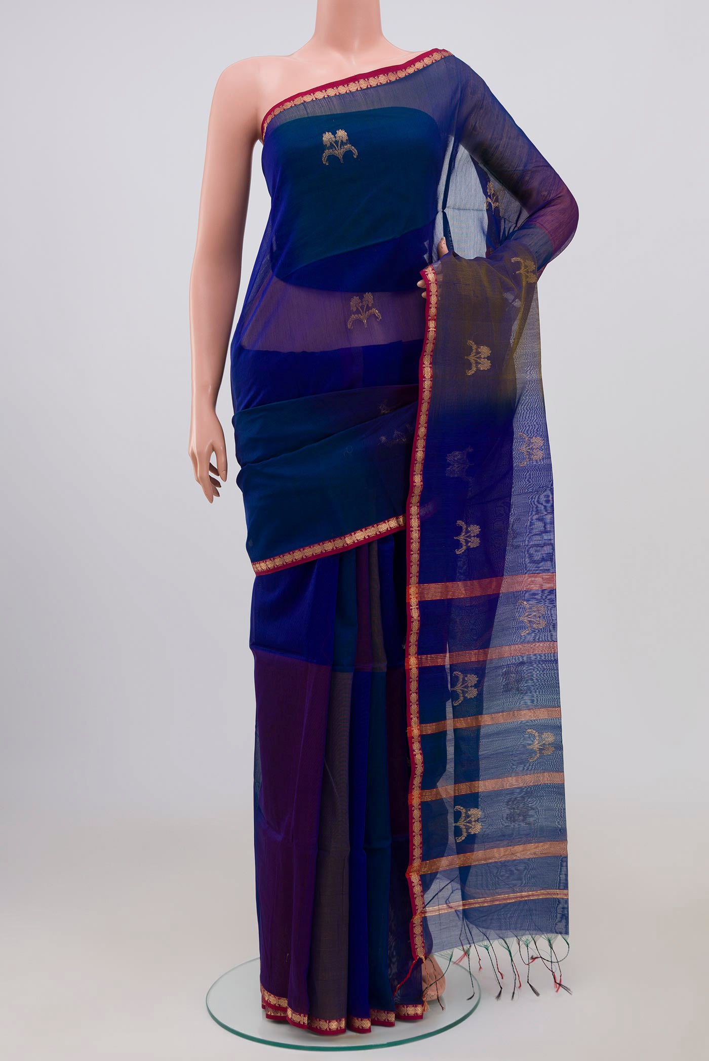 Blue Maheshwari Silk Cotton Saree with Zari Butta on the body and Thin Zari Line.  displayed on a mannequin