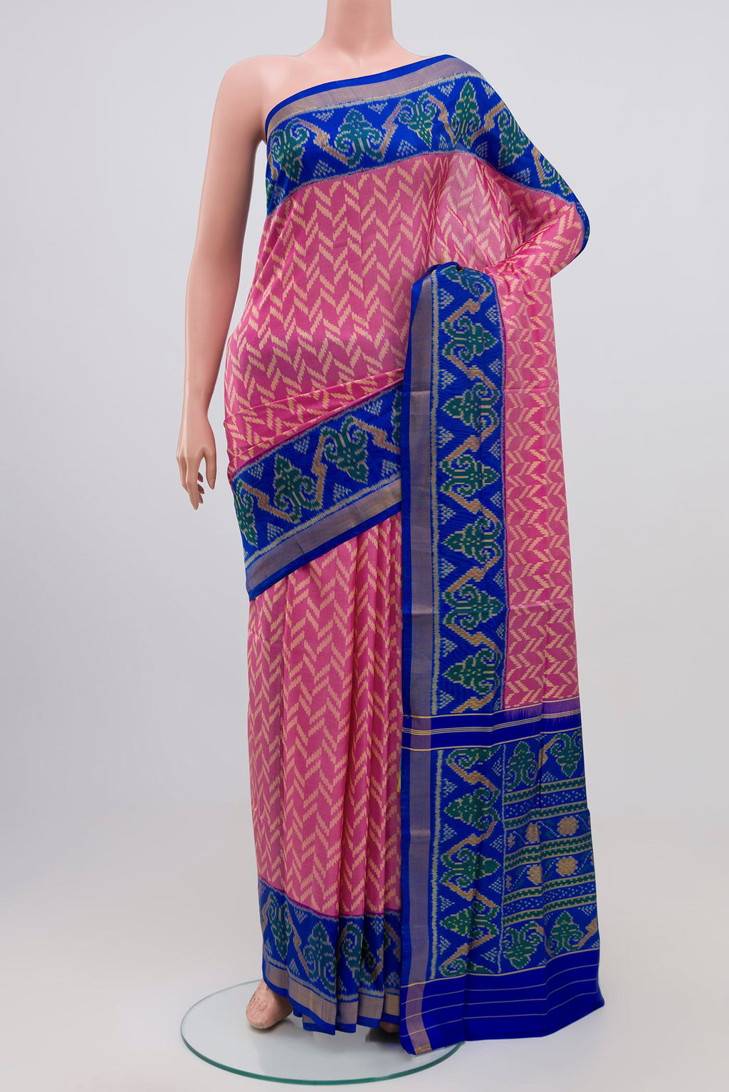 Pink Rajkot Patola Silk Saree with Ikat design on the body and Zari Border.  displayed on a mannequin