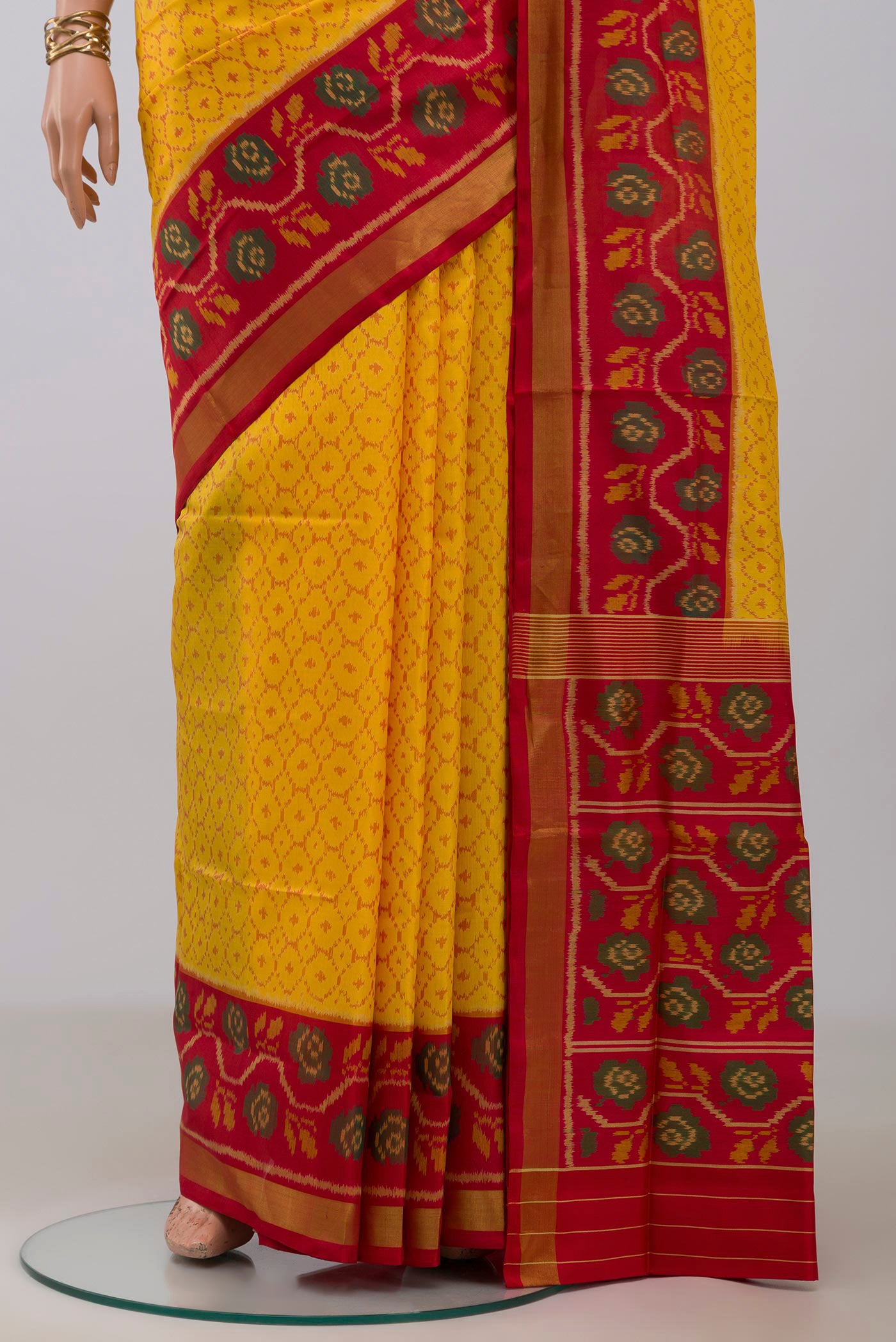 Pleats and pallu of Yellow Rajkot Patola Silk Saree with Ikat design on the body and Ikat Border. 