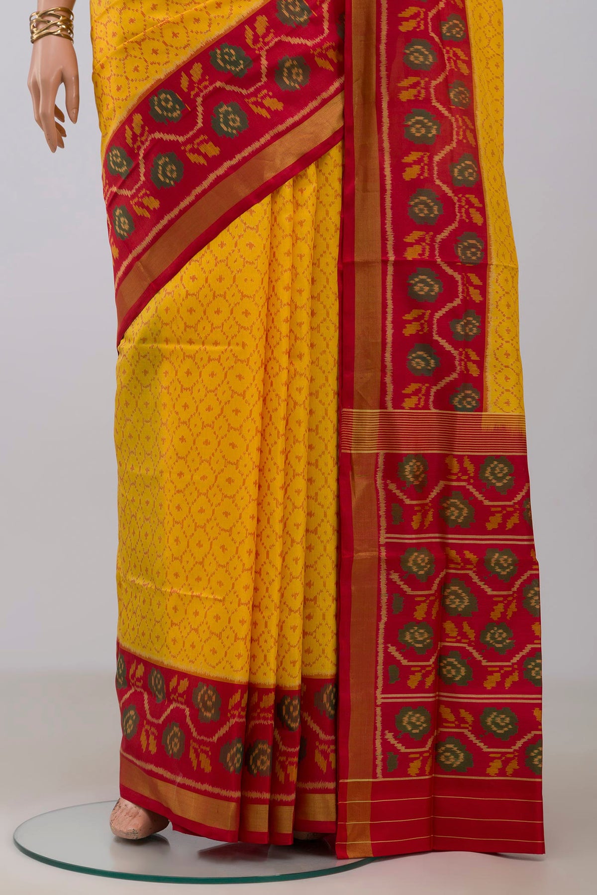 Pleats and pallu of Yellow Rajkot Patola Silk Saree with Ikat design on the body and Ikat Border. 