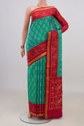 Pure Silk Turquoise Rajkot Patola Saree with Pure Ikat on the body and Ikat Border.  displayed on a mannequin