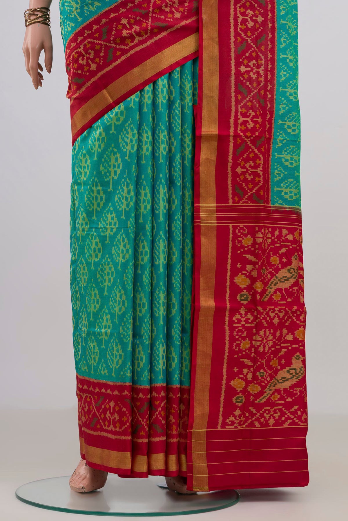 Pleats and pallu of Pure Silk Turquoise Rajkot Patola Saree with Pure Ikat on the body and Ikat Border. 