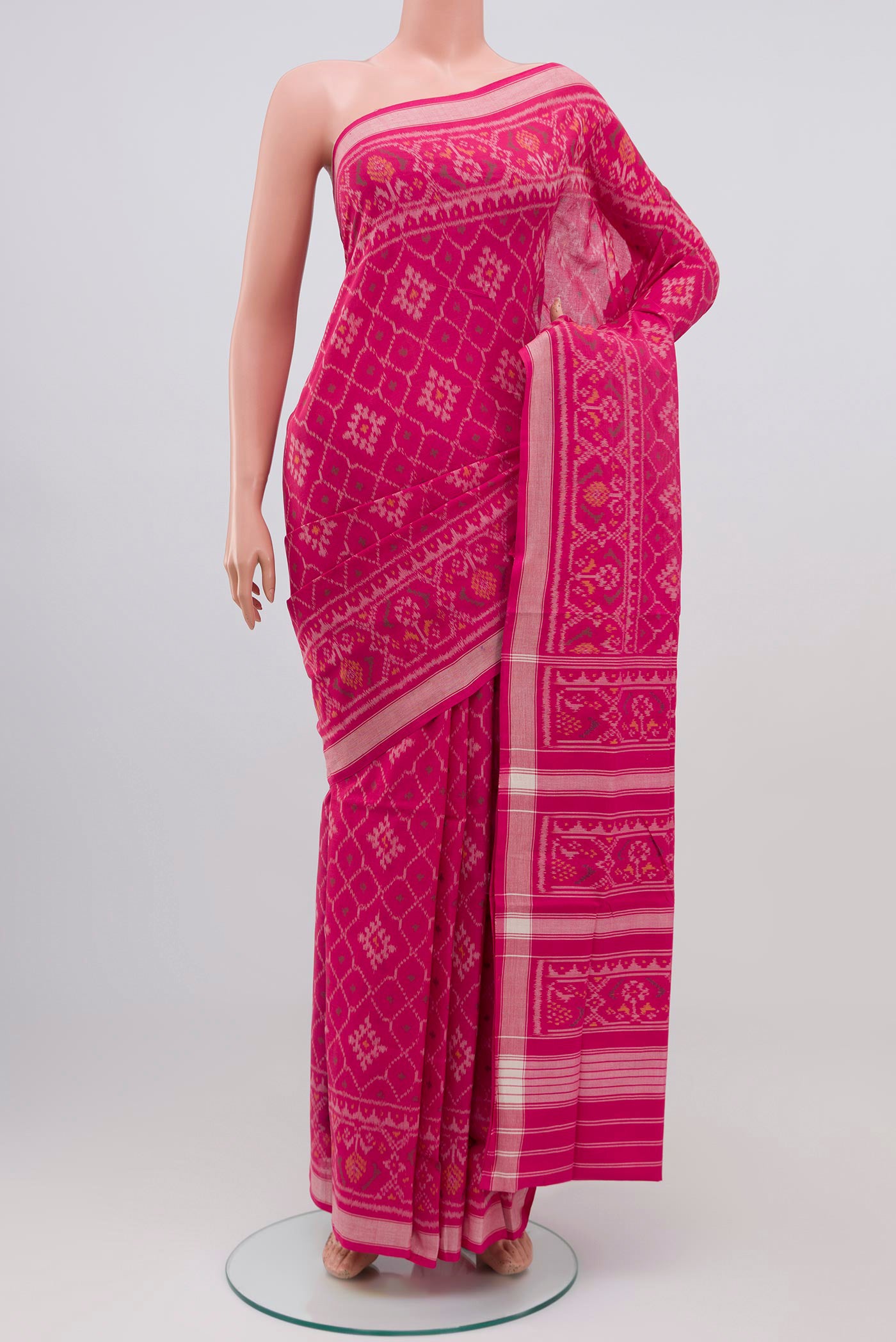 Pink Double Ikat Saree with Ikat design on the body and Plain Border.  displayed on a mannequin