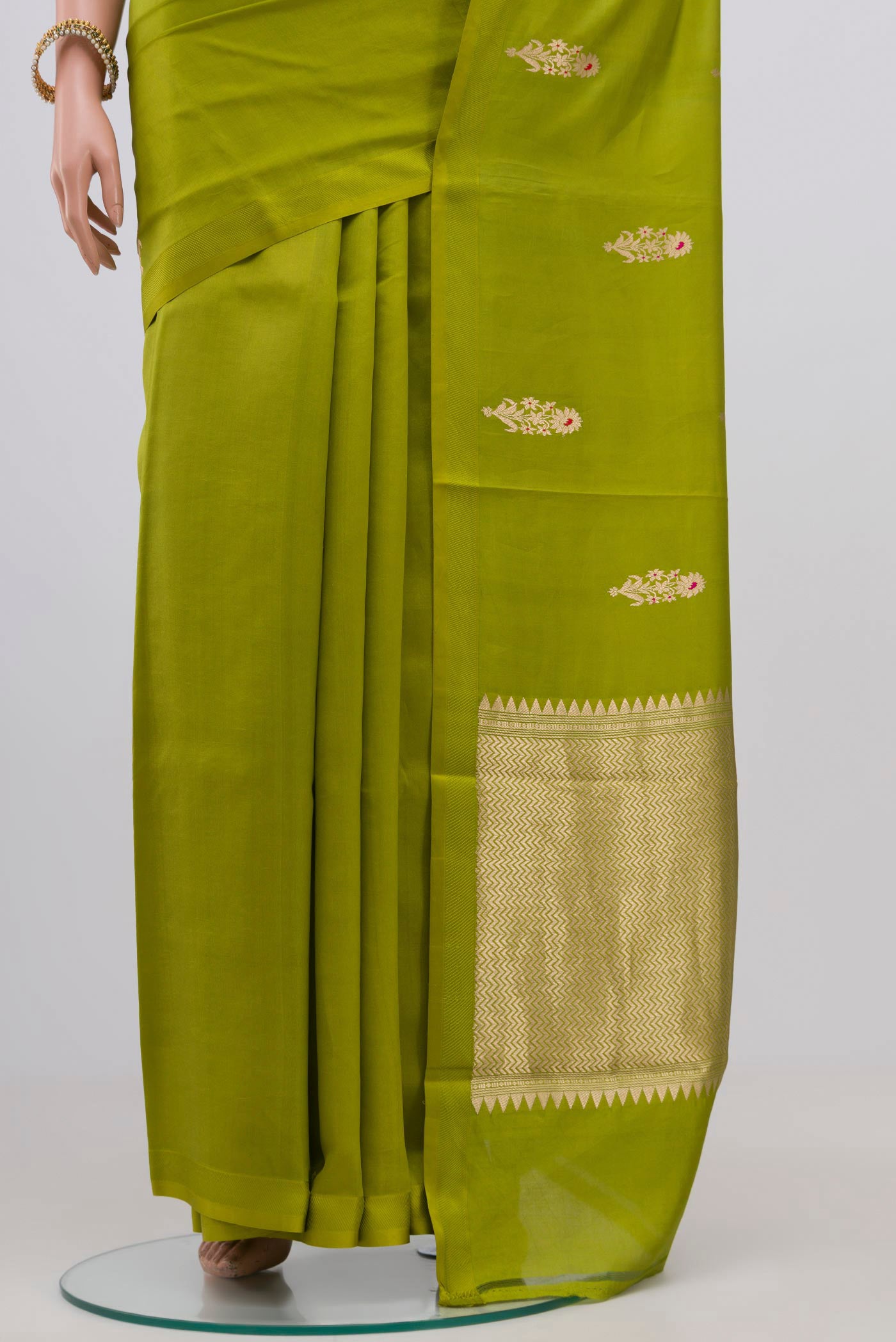 Pleats and pallu of Parrot Green Banarasi Katan Silk Saree with Zari Butta on the body and Zari Border. 