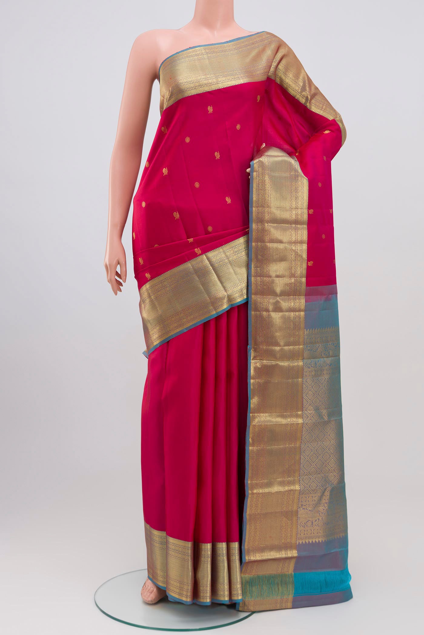 Pink Kanchipuram Saree with Zari Butta on the body and Zari Border.  displayed on a mannequin