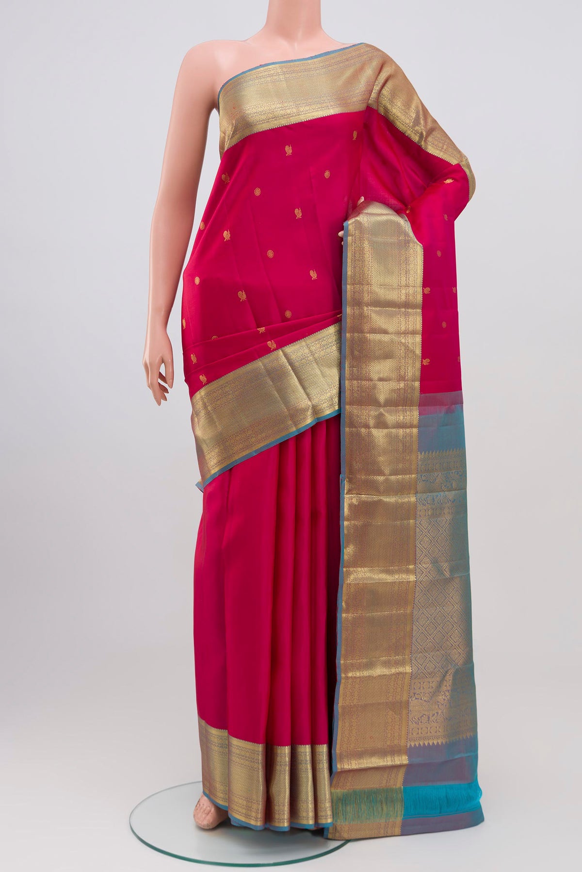 Pink Kanchipuram Saree with Zari Butta on the body and Zari Border.  displayed on a mannequin