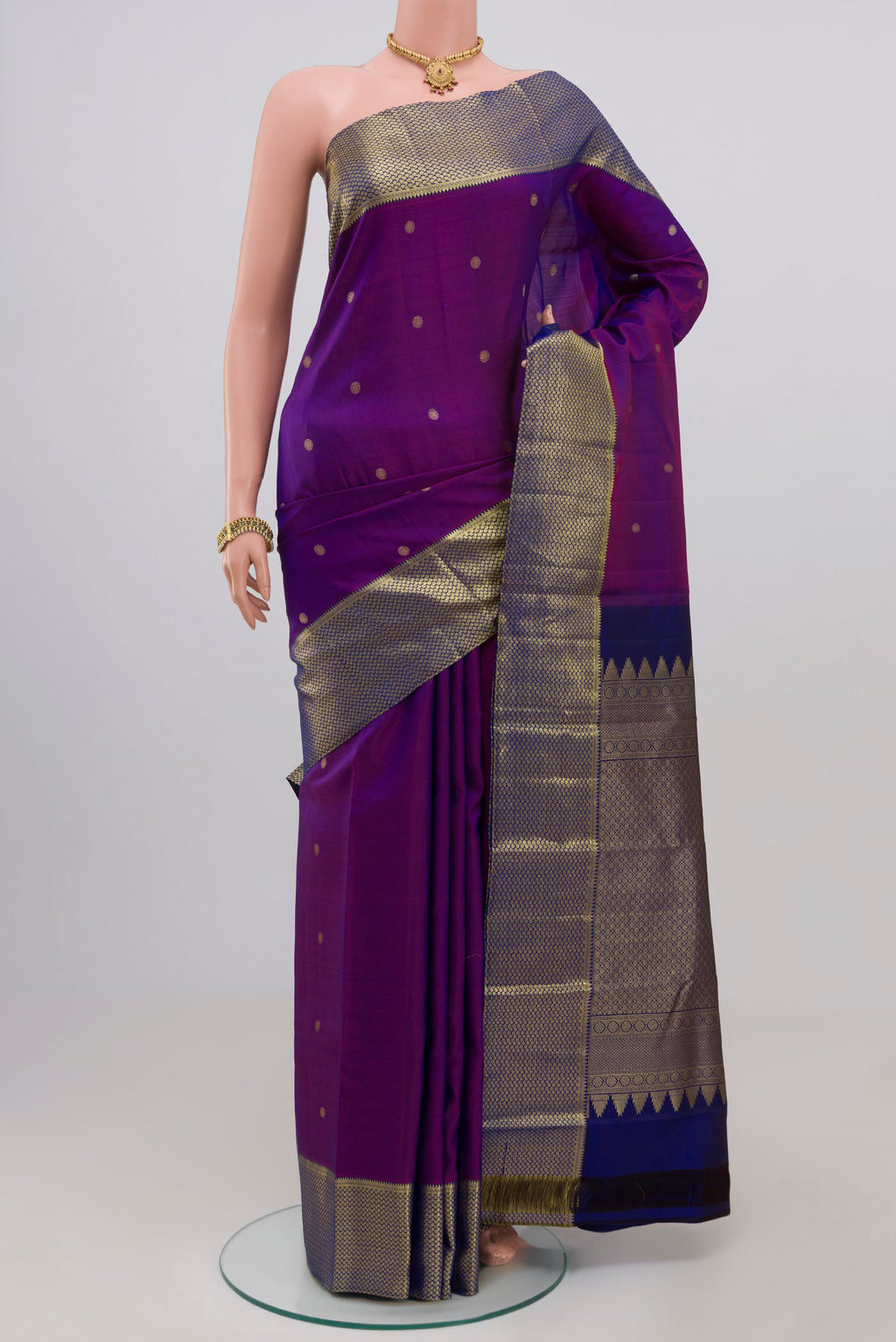 Purple Kanchipuram Silk Saree with Zari Butta on the body and Zari Border.  displayed on a mannequin