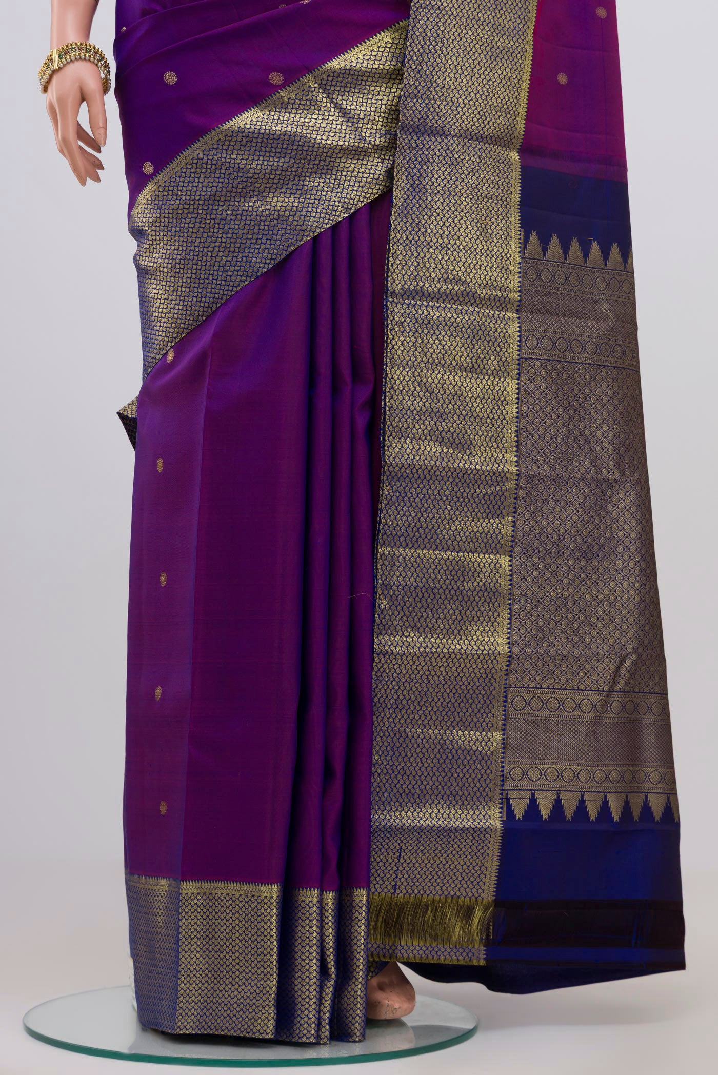 Pleats and pallu of Purple Kanchipuram Silk Saree with Zari Butta on the body and Zari Border. 
