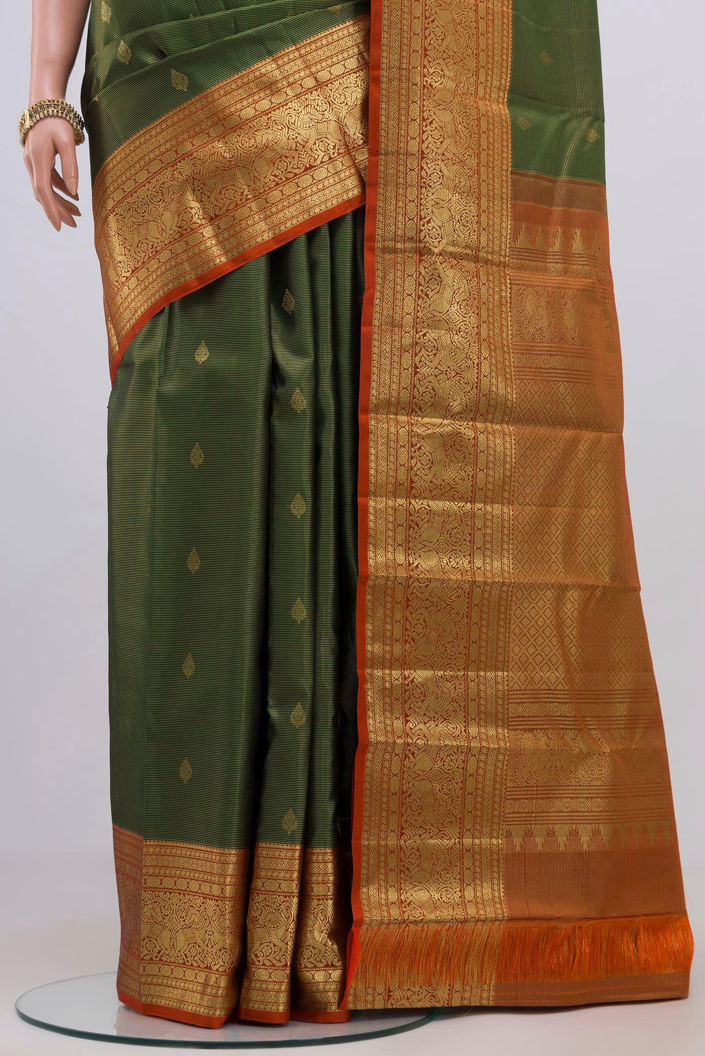 Pleats and pallu of Green Kanjivaram Silk Saree with Zari Butta on the body and Zari Border. 