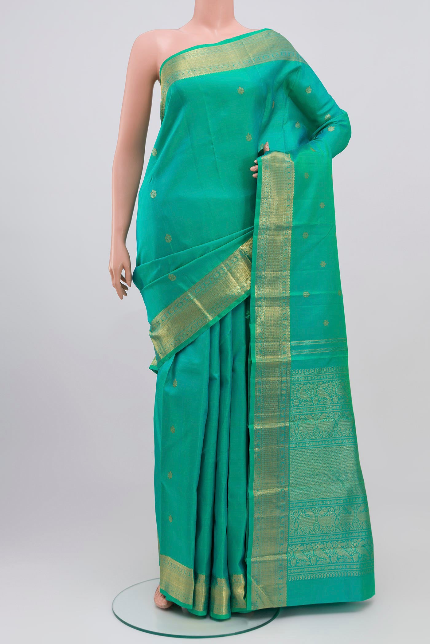 Pure Silk Pure Zari Green Kanjivaram Saree with Zari Butta on the body and Zari Border.  displayed on a mannequin