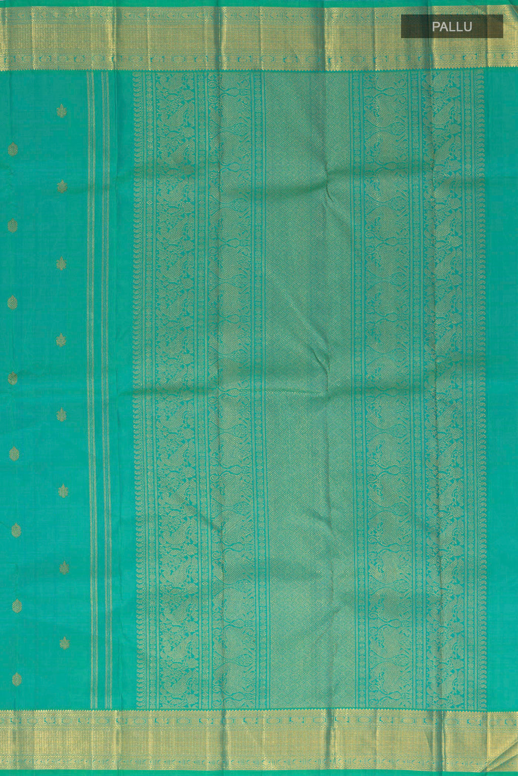 Close up image of the pallu of Pure Silk Pure Zari Green Kanjivaram Saree with Zari Butta on the body and Zari Border. 