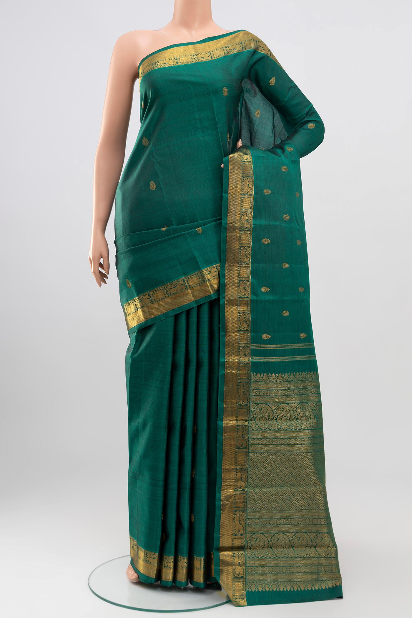 Pure Silk Pure Zari Green Kanchipuram Saree with Zari Butta on the body and Zari Border.  displayed on a mannequin