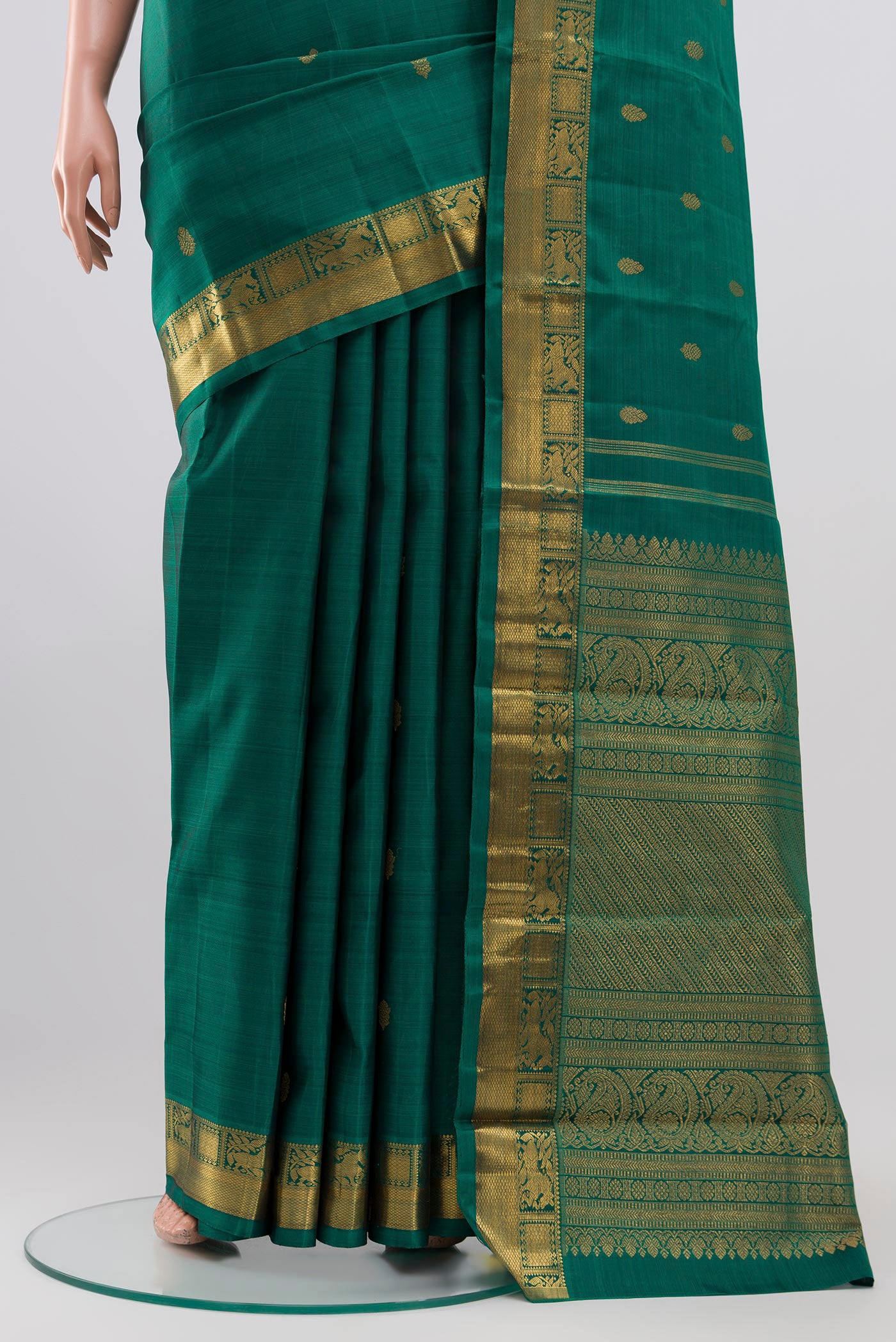 Pleats and pallu of Pure Silk Pure Zari Green Kanchipuram Saree with Zari Butta on the body and Zari Border. 