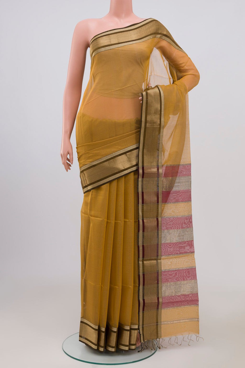Beige Maheshwari Silk Cotton Saree with Plain Body and Zari Border.  displayed on a mannequin