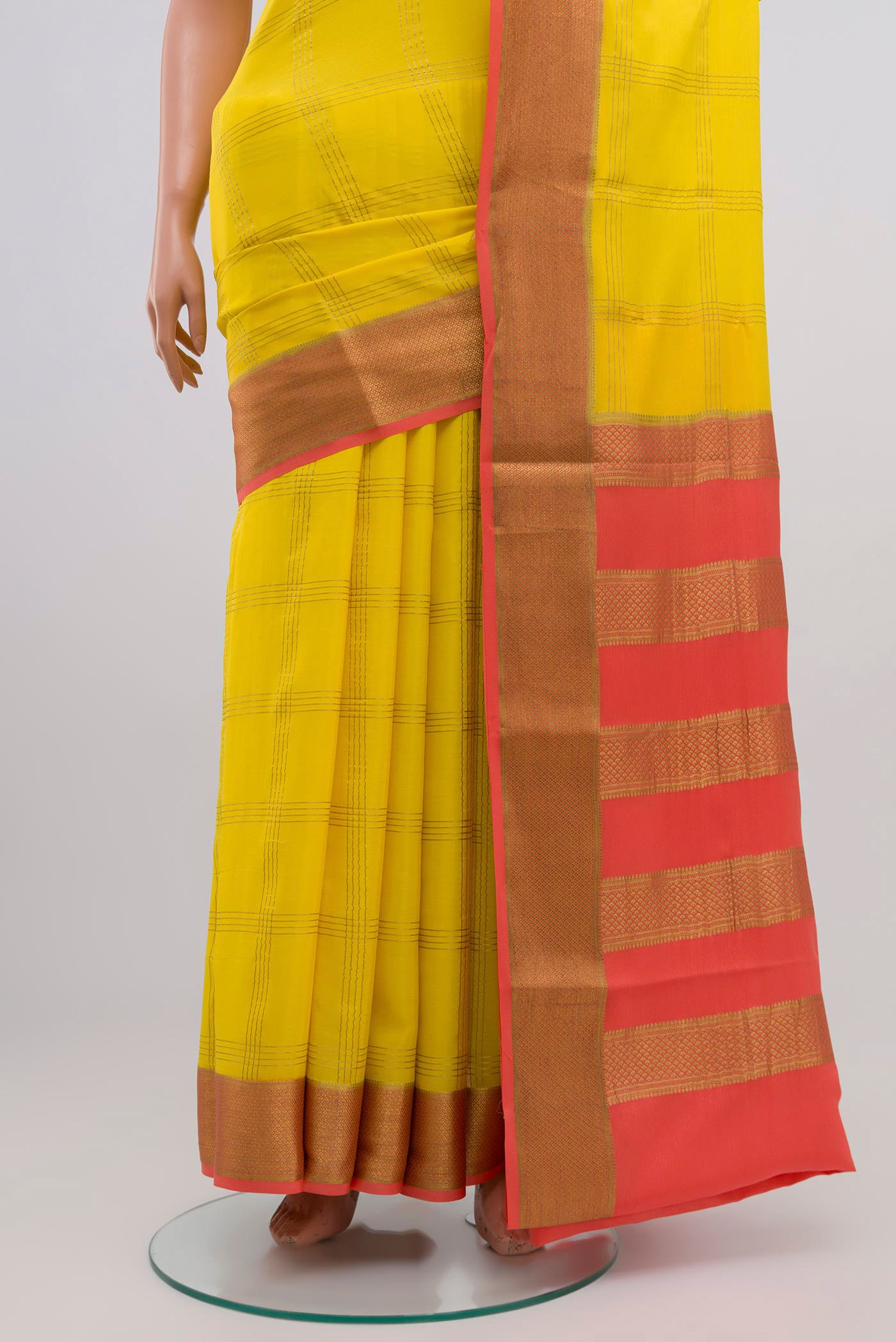 Pleats and pallu of Yellow Crepe Saree with Checked design on the body and Zari Border. 