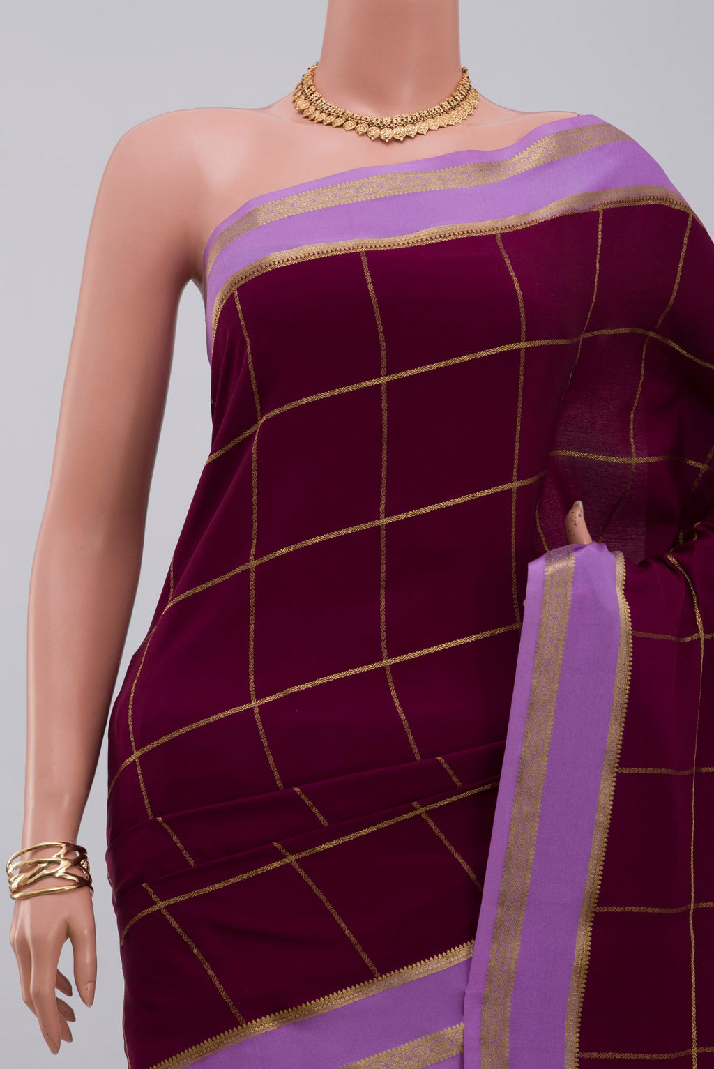 Border image of Purple Crepe Saree with Checked design on the body and Thin Zari Line. 