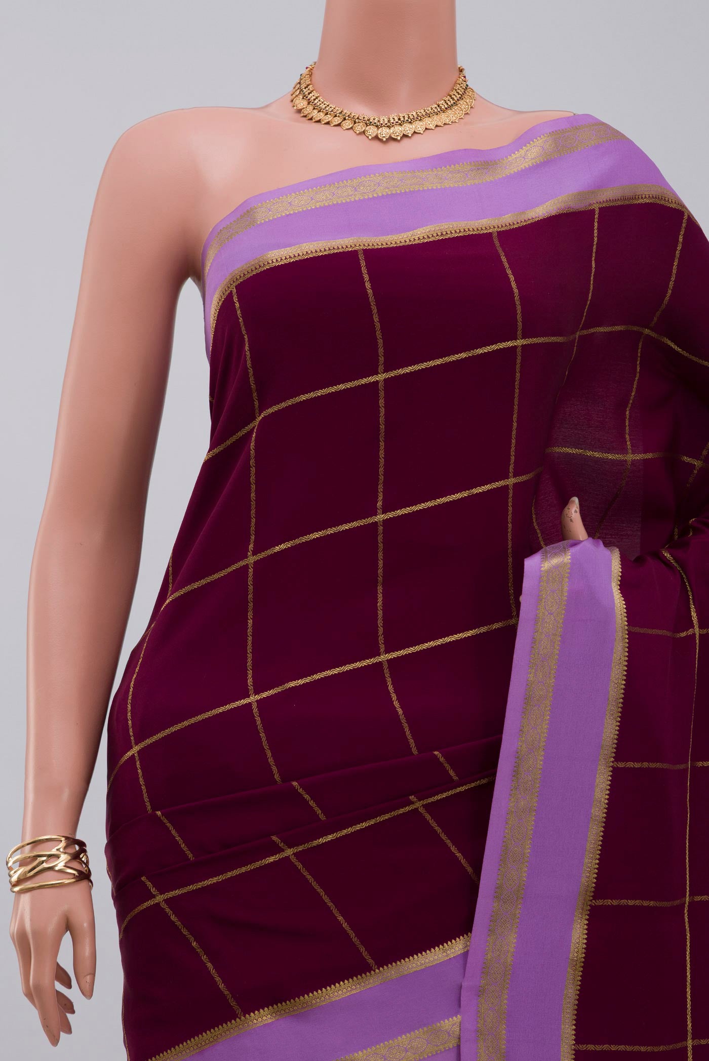 Border image of Purple Crepe Saree with Checked design on the body and Thin Zari Line. 