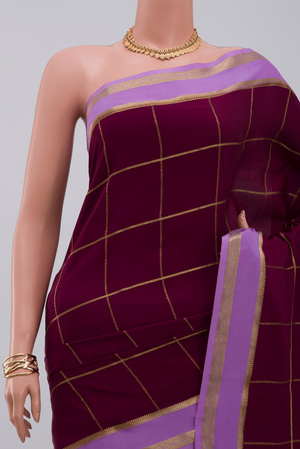 Border image of Purple Crepe Saree with Checked design on the body and Thin Zari Line. 
