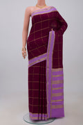 Purple Crepe Saree with Checked design on the body and Thin Zari Line.  displayed on a mannequin