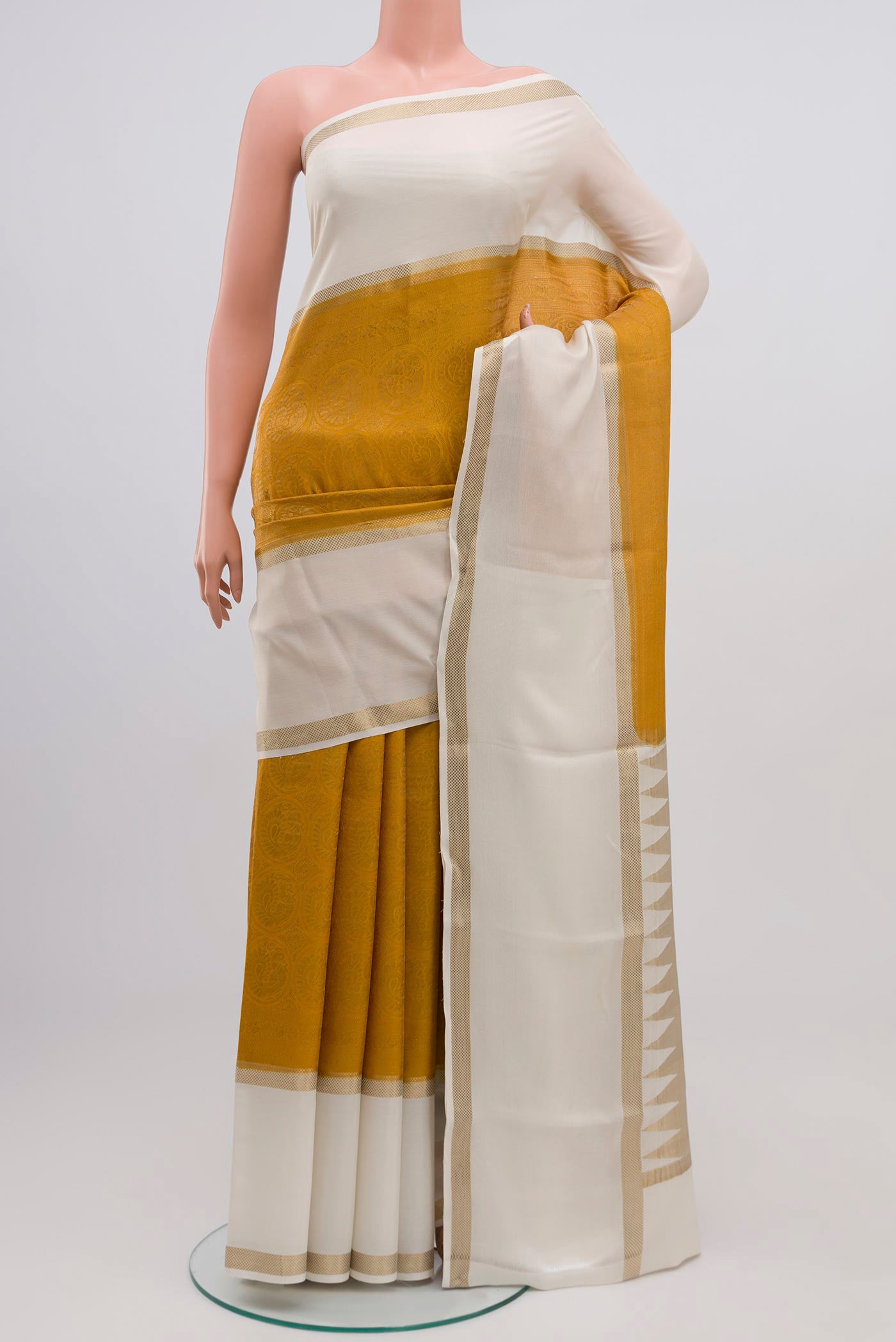Mustard Mysore Crepe Saree with Zari Brocade on the body and Zari Border.  displayed on a mannequin