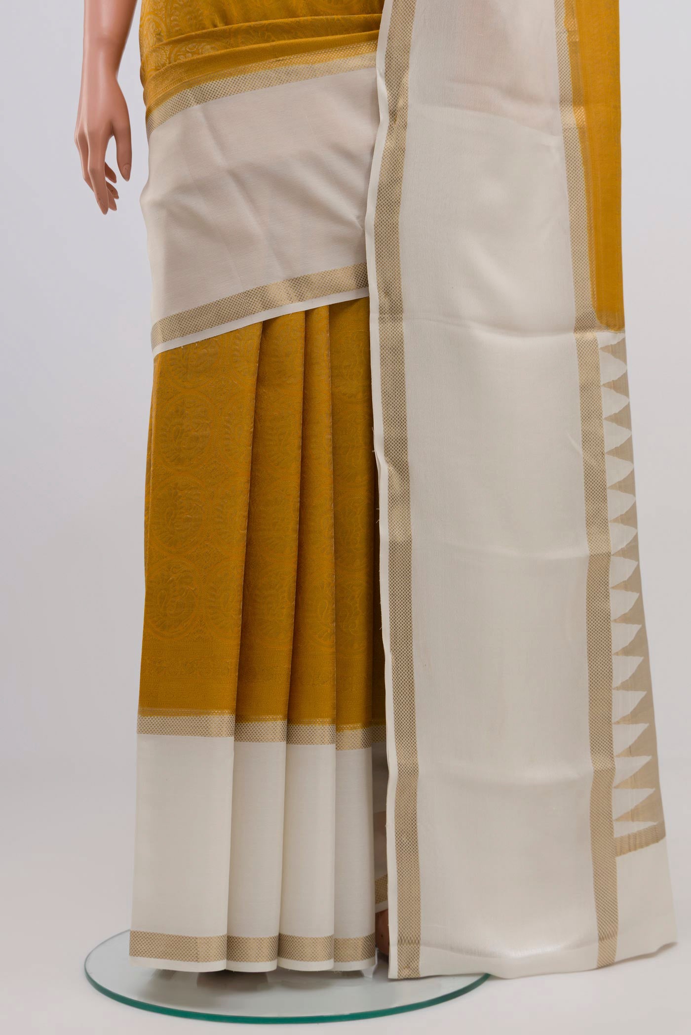 Pleats and pallu of Mustard Mysore Crepe Saree with Zari Brocade on the body and Zari Border. 