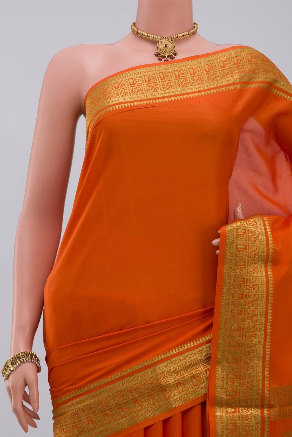 Border image of Orange Crepe Saree with Plain Body and Zari Border. 