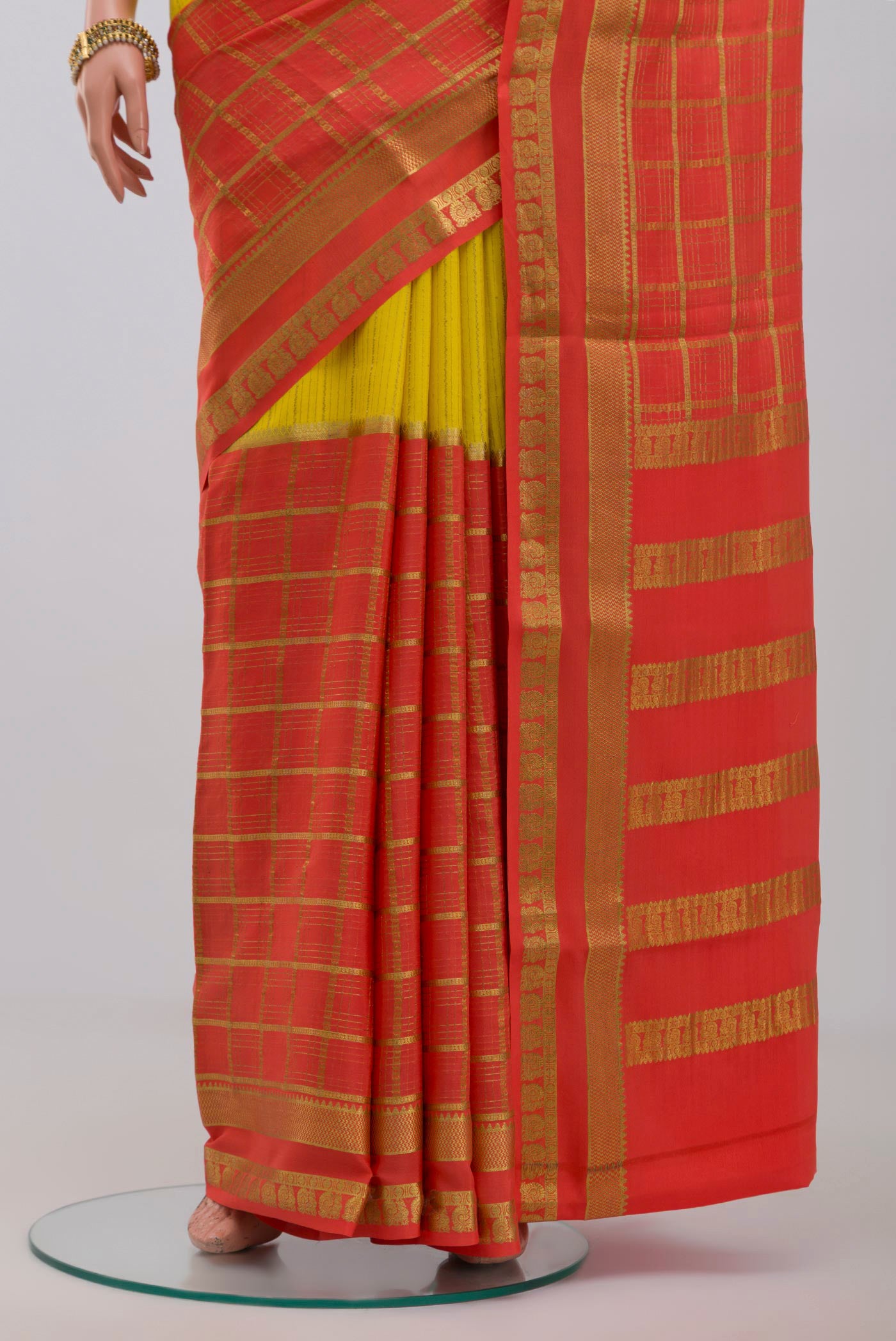 Pleats and pallu of Yellow Crepe Saree with Fancy on the body and Zari Border. 