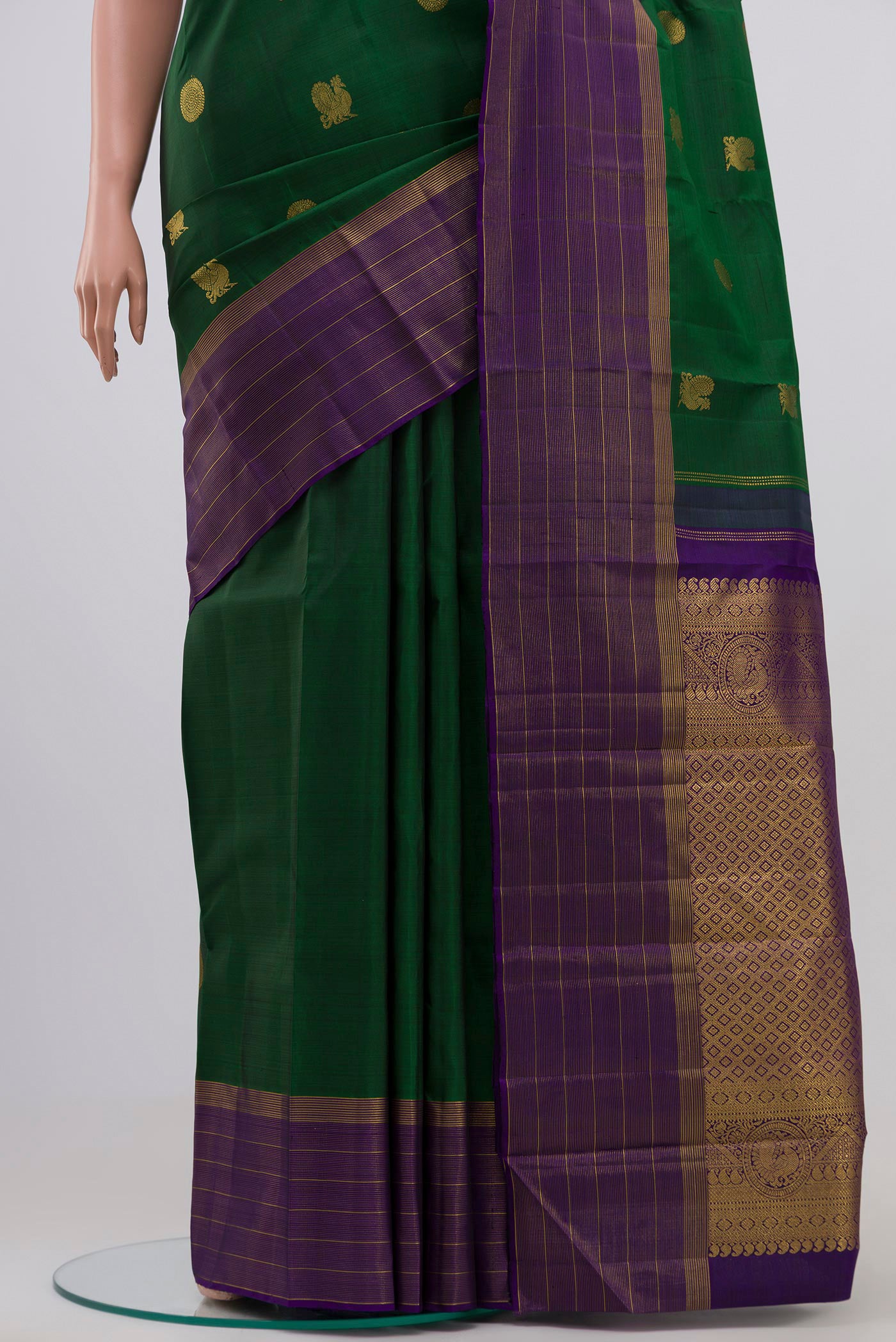 Pleats and pallu of Bottle Green Kanjivaram Silk Saree with Zari Butta on the body and Zari Border. 