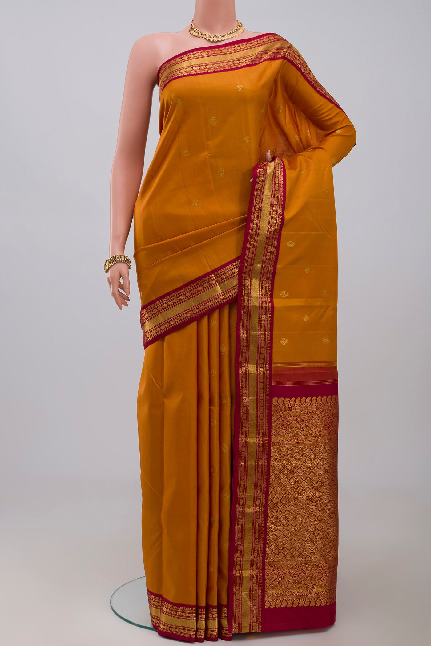 Pure Silk Pure Zari Yellow Kanchipuram Saree with Zari Butta on the body and Zari Border.  displayed on a mannequin
