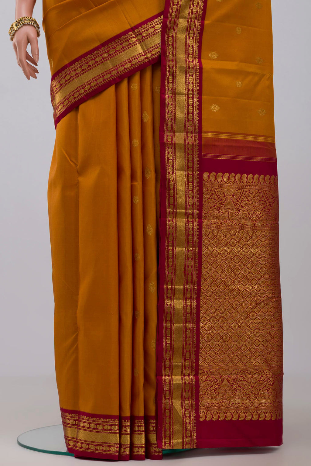 Pleats and pallu of Pure Silk Pure Zari Yellow Kanchipuram Saree with Zari Butta on the body and Zari Border. 
