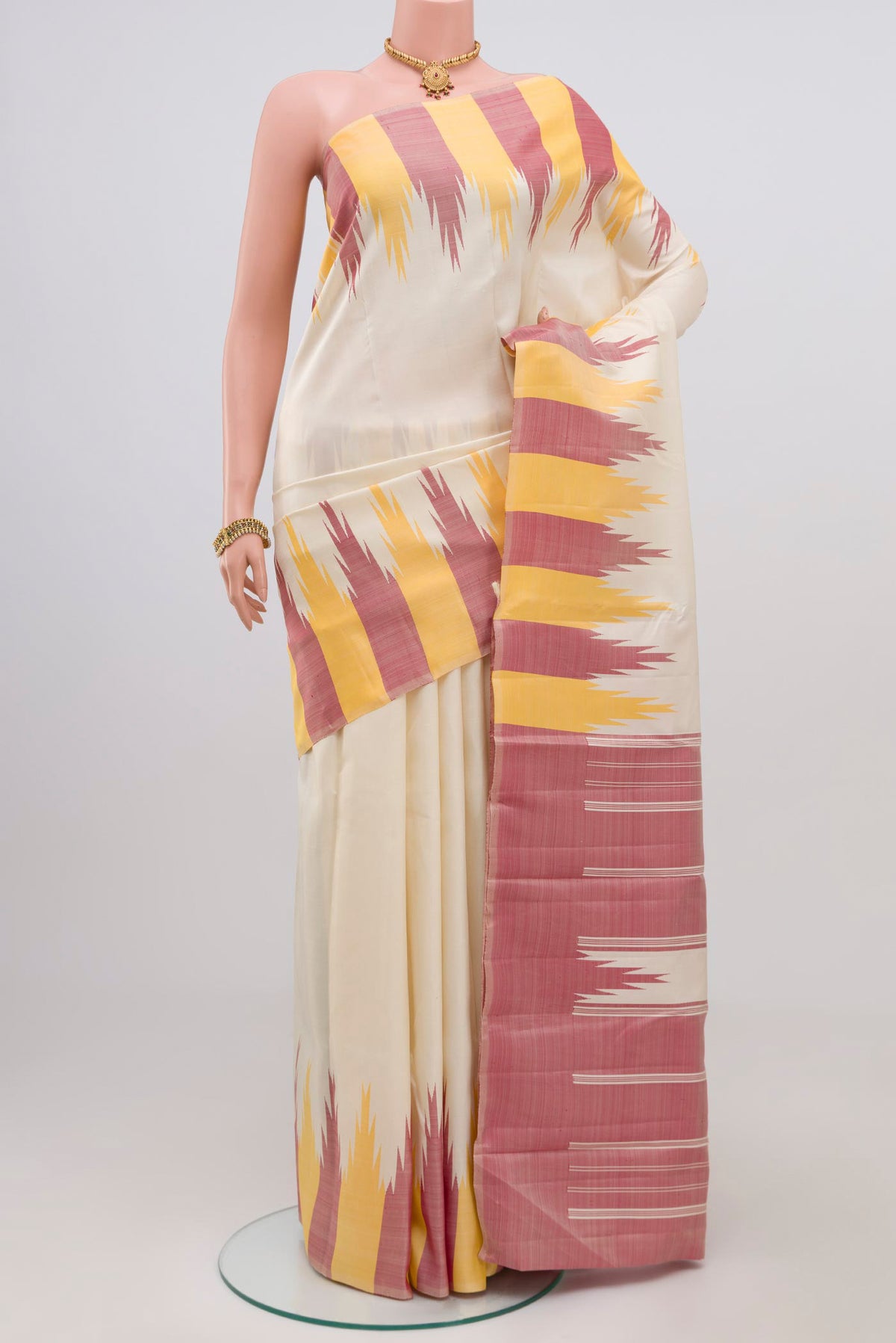 Off White Kanchipuram Silk Saree with Plain Body and Temple Border.  displayed on a mannequin