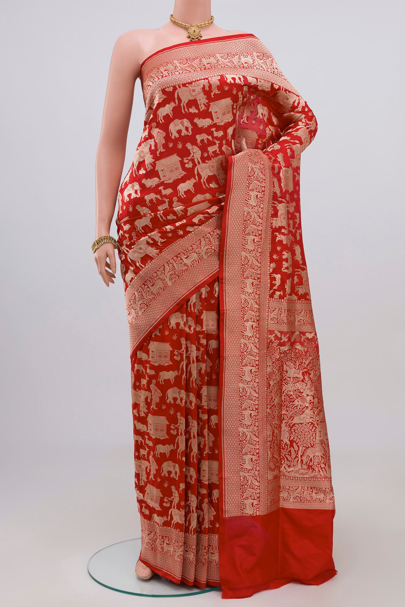 Red Banarasi Saree with Zari Brocade on the body and Zari Border.  displayed on a mannequin