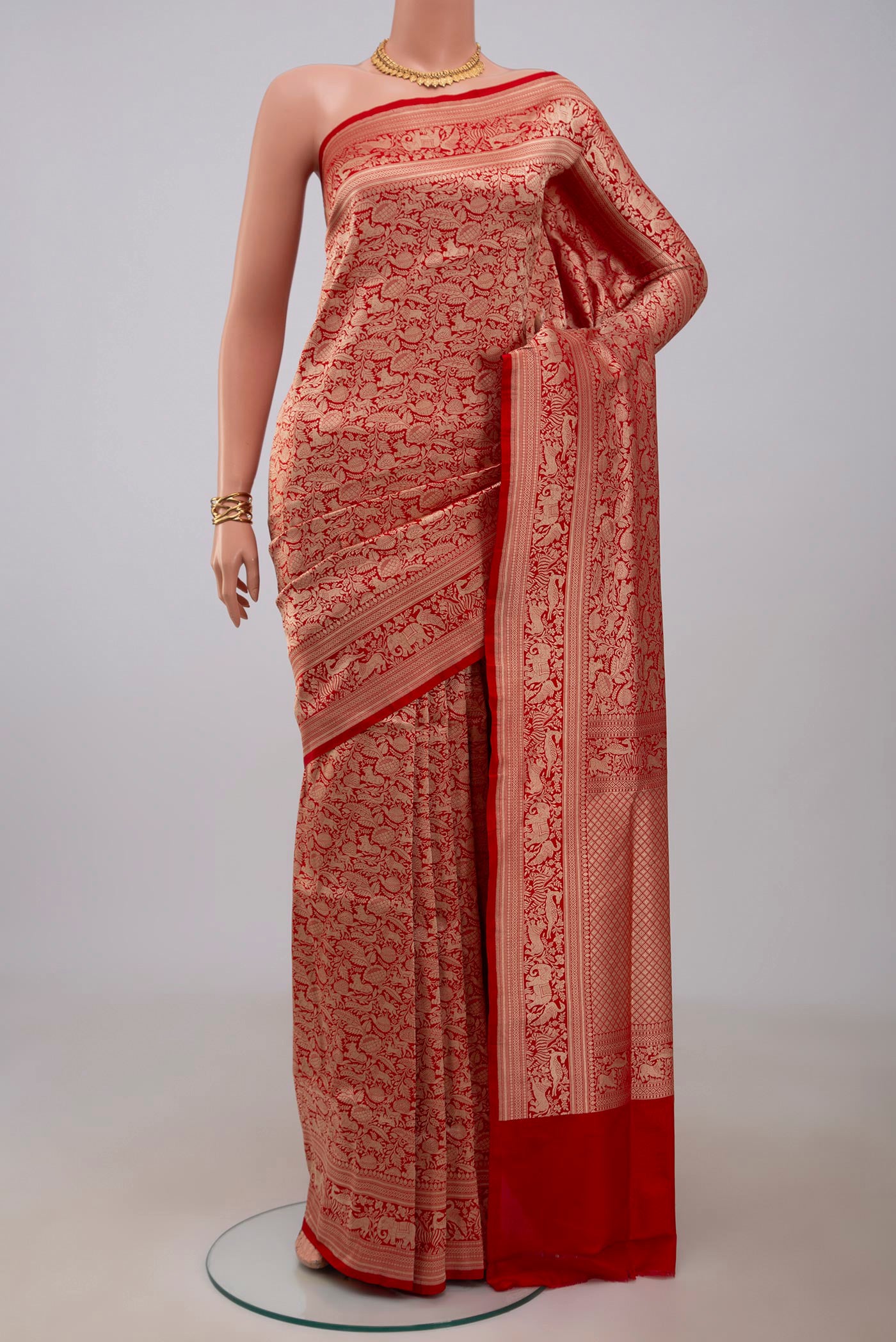 Red Banarasi Silk Saree with Zari Brocade on the body and Fancy Border.  displayed on a mannequin