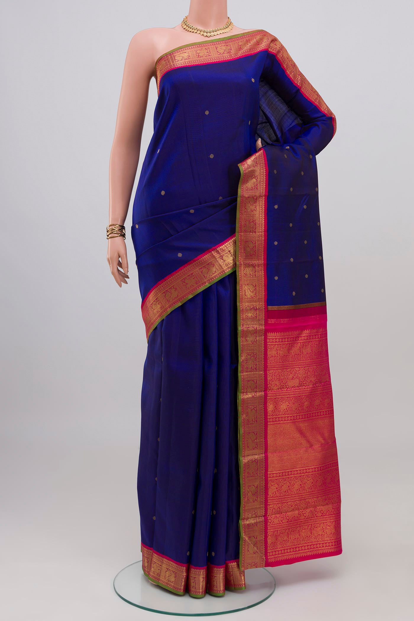 Pure Silk Pure Zari Blue Kanjivaram Saree with Zari Butta on the body and Zari Border.  displayed on a mannequin