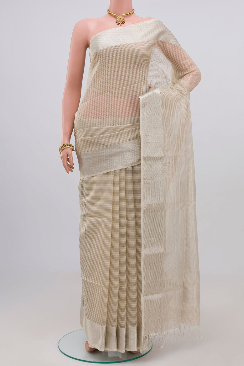 White Maheshwari Silk Cotton Saree with Checked design on the body and Zari Border.  displayed on a mannequin