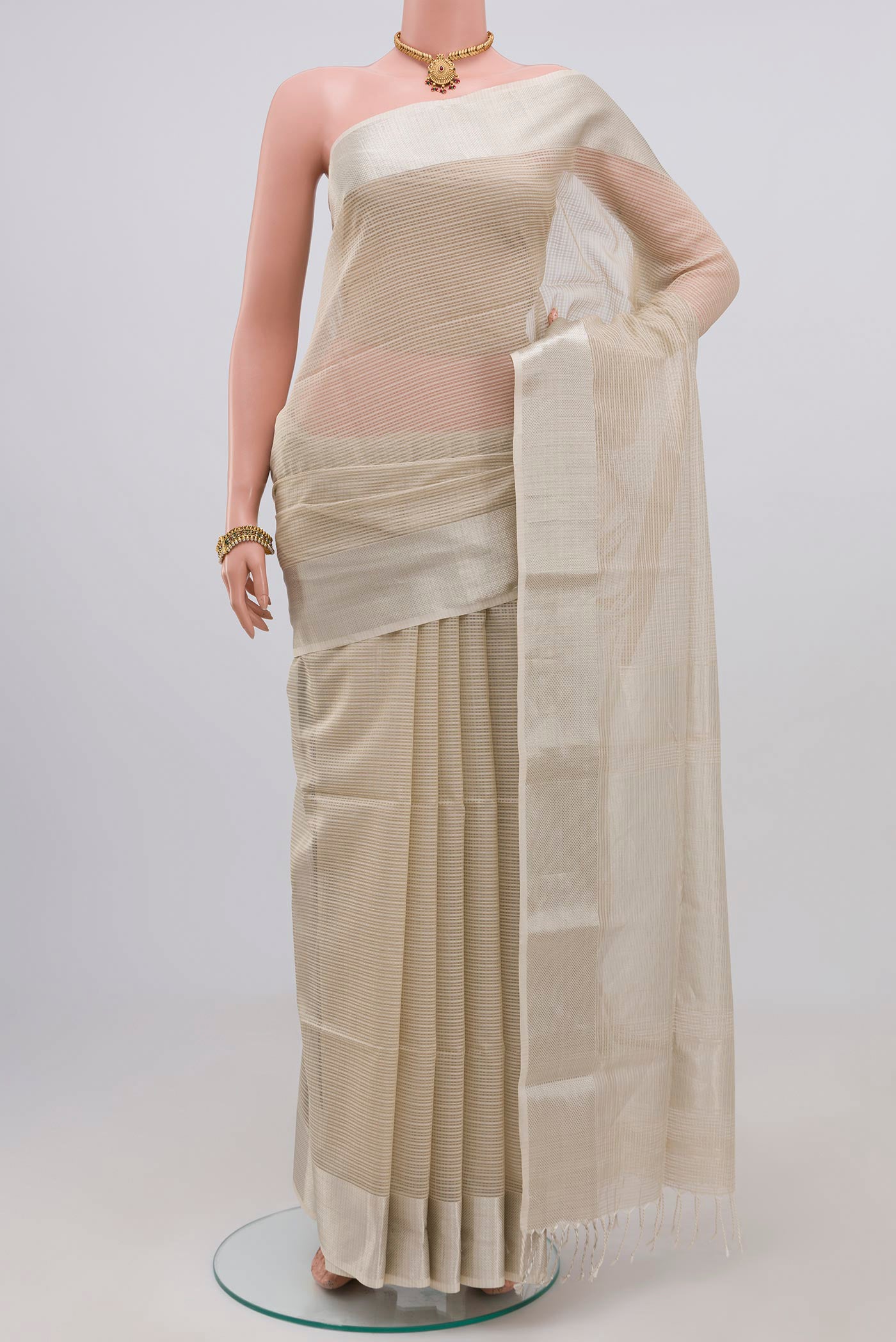 White Maheshwari Silk Cotton Saree with Checked design on the body and Zari Border.  displayed on a mannequin