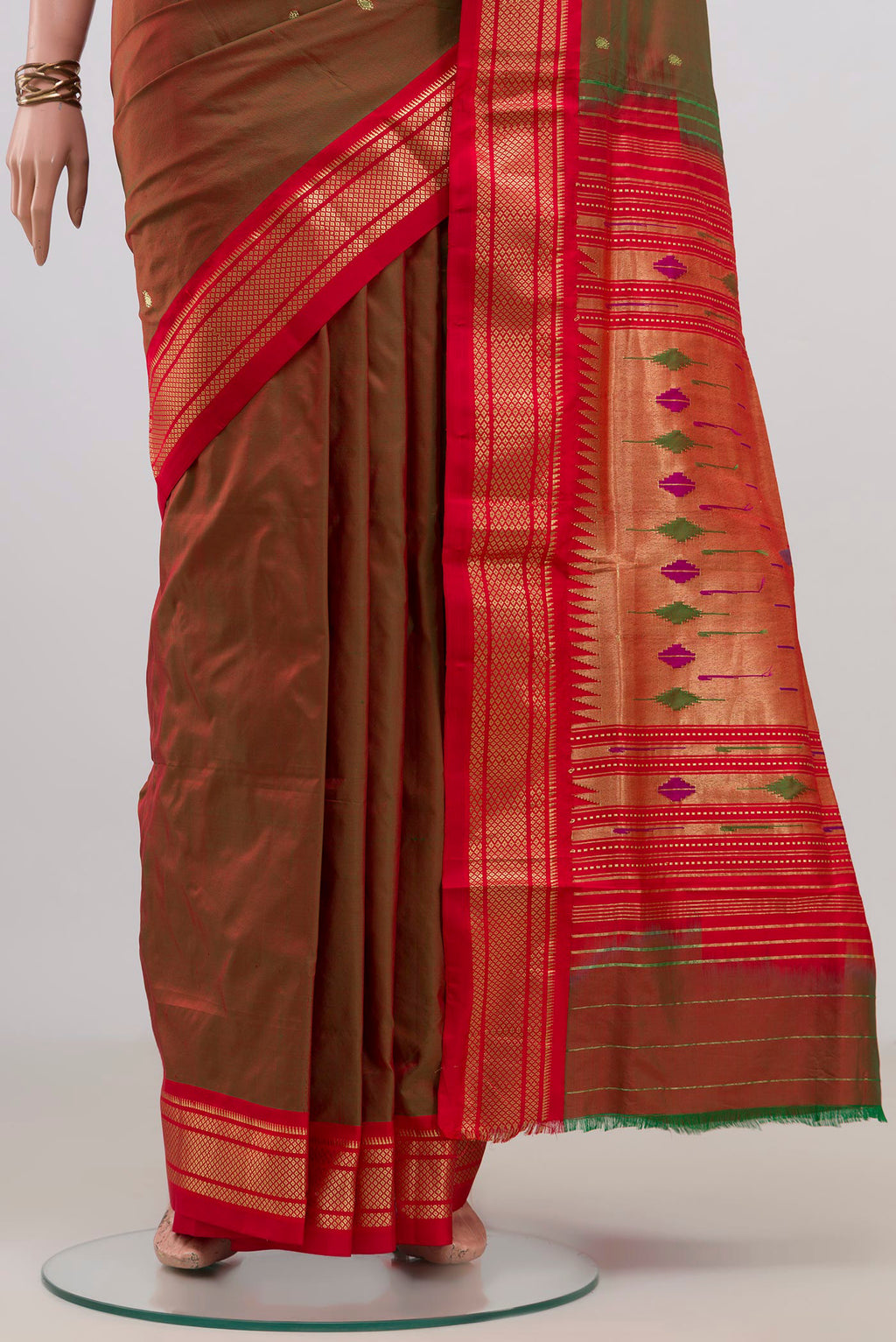 Pleats and pallu of Pure Silk Green with Red Color Paithani Saree with Zari Butta on the body and Zari Border. 